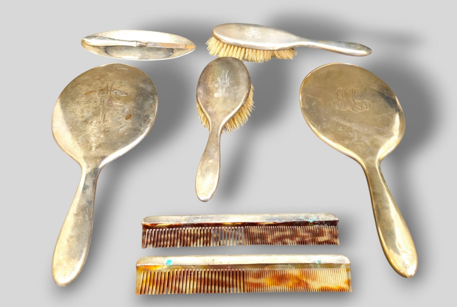 Assembled Sterling Silver Dresser Set: Assembled Sterling Silver Dresser Set. 8 pieces total. 2 vanity mirrors, 2 brushes, 2 combs, file and pin holder. Mirror 5w x 12 1/2h. Brushes 2 3/4w x 8 1/4h.