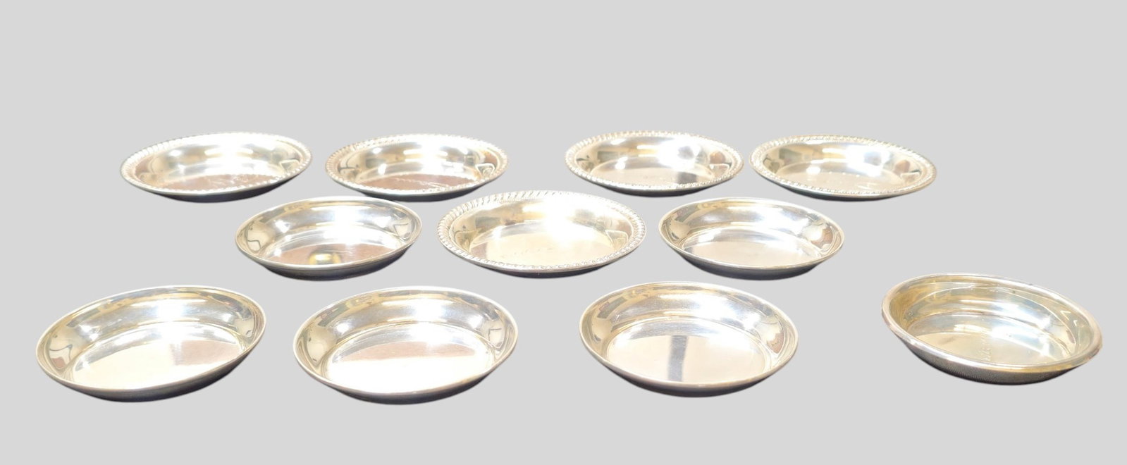 Assembled Sterling Silver Mint Dishes: Assembled Sterling Silver Mint Dishes. 11 total. 6 International Sterling Co. 2 3/4 dia x 1/4h. 5 sterling with gadroon borders 3 3/4dia x 3/8h. Weight 8.455 ozt.