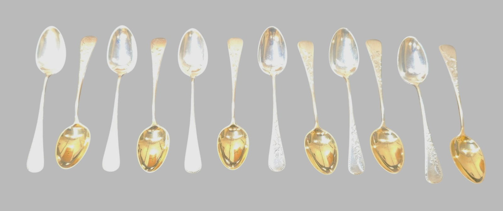 Frank Whiting Lily Sterling Silver Tea Spoons: Frank Whiting Lily Sterling Silver Tea Spoons. Set of 12. 6 Gold wash spoons. Engraved Lily handles. 5 inches long. Weight 6.42 ozt.
