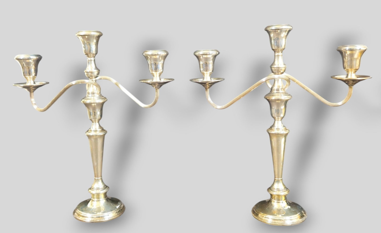 Sterling Silver Three Branch Candelabras: Sterling Silver Three Branch Candelabras. Pair. Marked sterling, #1006 and weighted reinforced.12 3/8w x 4d x 14h.