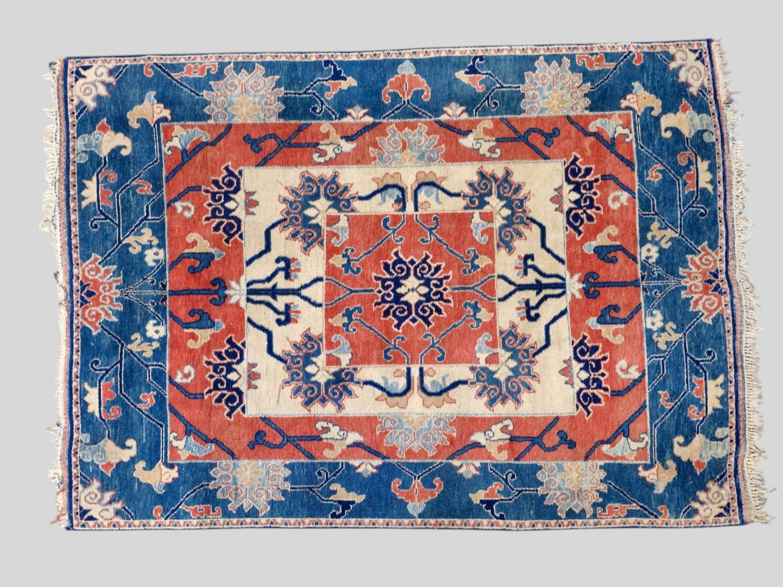 Indian Heriz Area Rug: Indian Heriz Area Rug. Late 20th Century. All over garden design over a geometric rectangular layers. Pastel in colors. 4ft 9in x 6ft 5in.