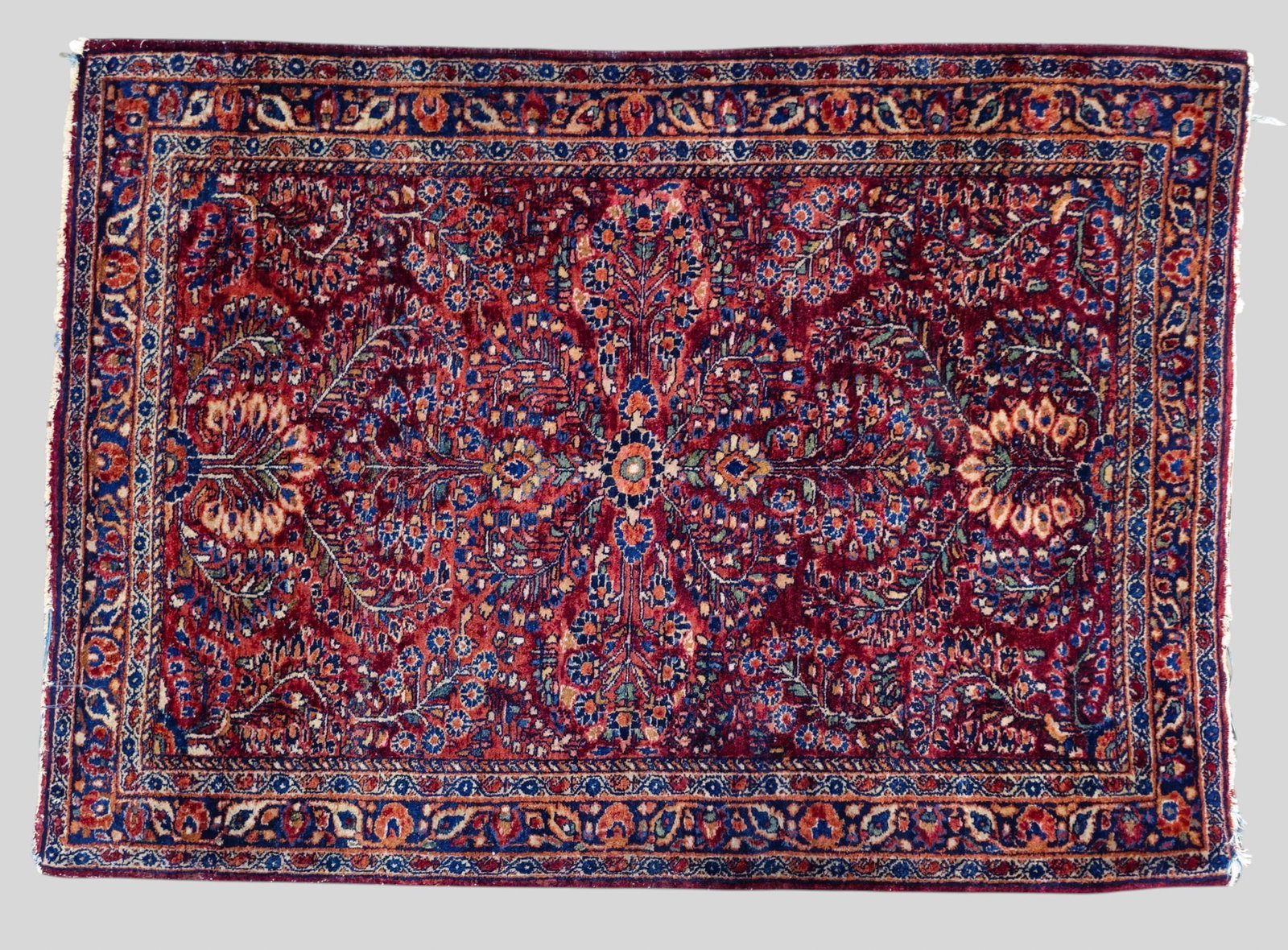 Sarouk Area Rug: Sarouk Area Rug 1940s. All over garden design over a red field. 3ft 4in x 4ft 7in.