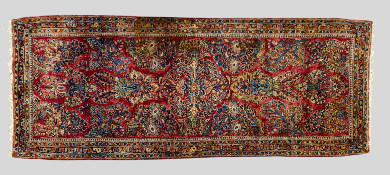 Sarouk Runner: Sarouk Runner 1950s. All over garden design over a red field. 2ft 7 1/2in x 6ft 5in.