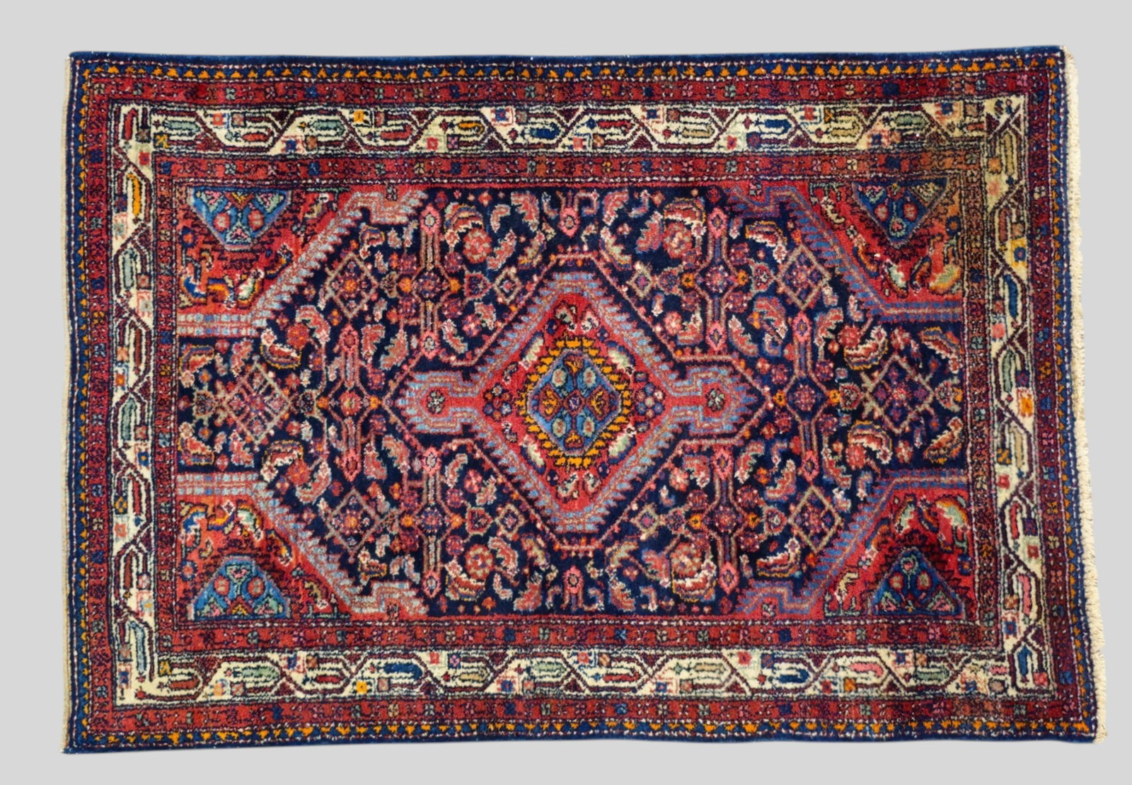 Heriz Area Rug: Heriz Area Rug 1940s. All over garden and geometric design over a navy field. Multiple layer borders. 3ft 6in x 5ft 3/4in.