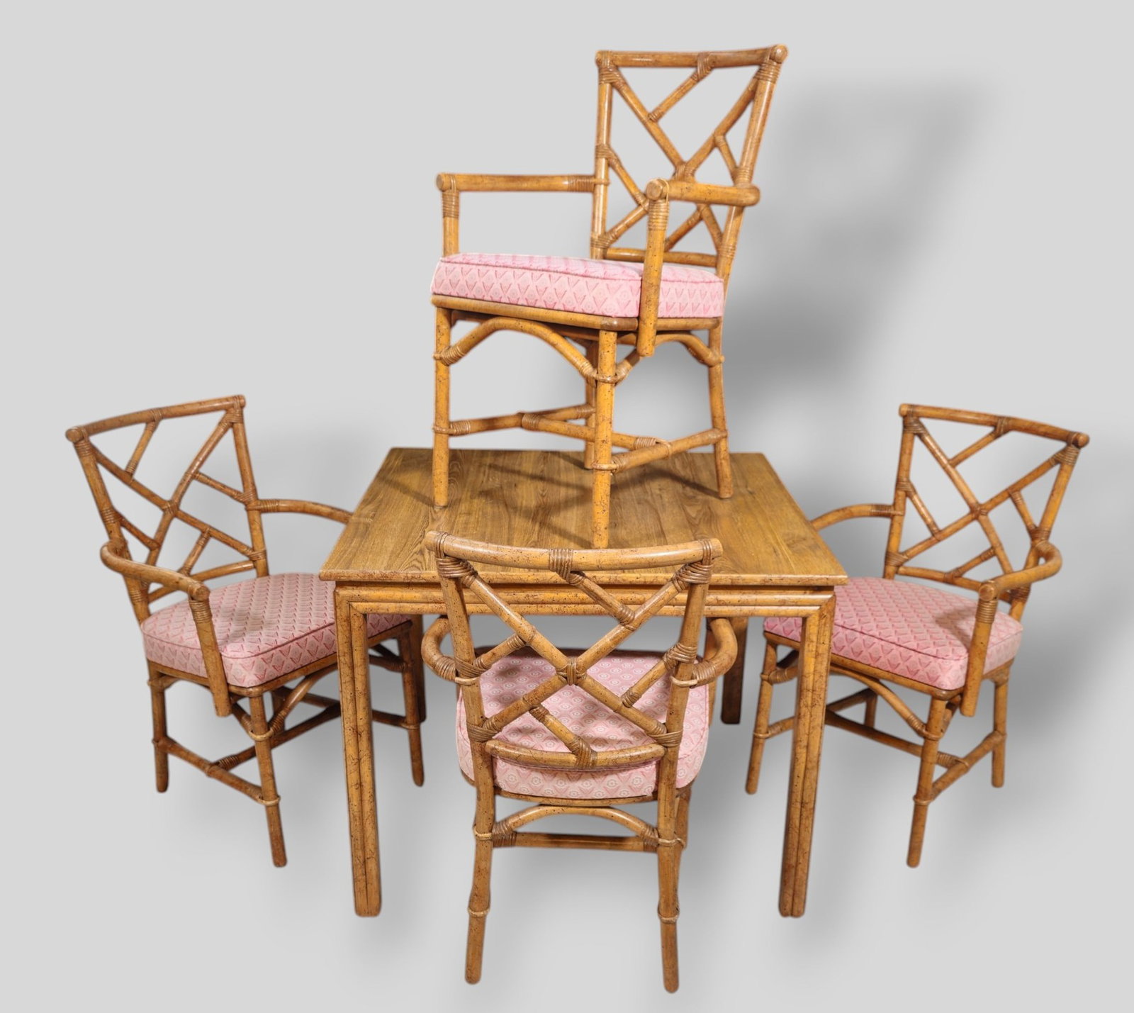 Ficks Reed MCM Bamboo Dining Table and Chairs: Ficks Reed MCM Rattan Dining Table and chairs . Ficks Reed Inc. USA. 1970s. Rattan and upholstery. Table - 36 3/4w x 36 3/4d x 29h. Chairs - 21 1/2w x 21 1/2d x 31 1/2h. SH-19 1/2.