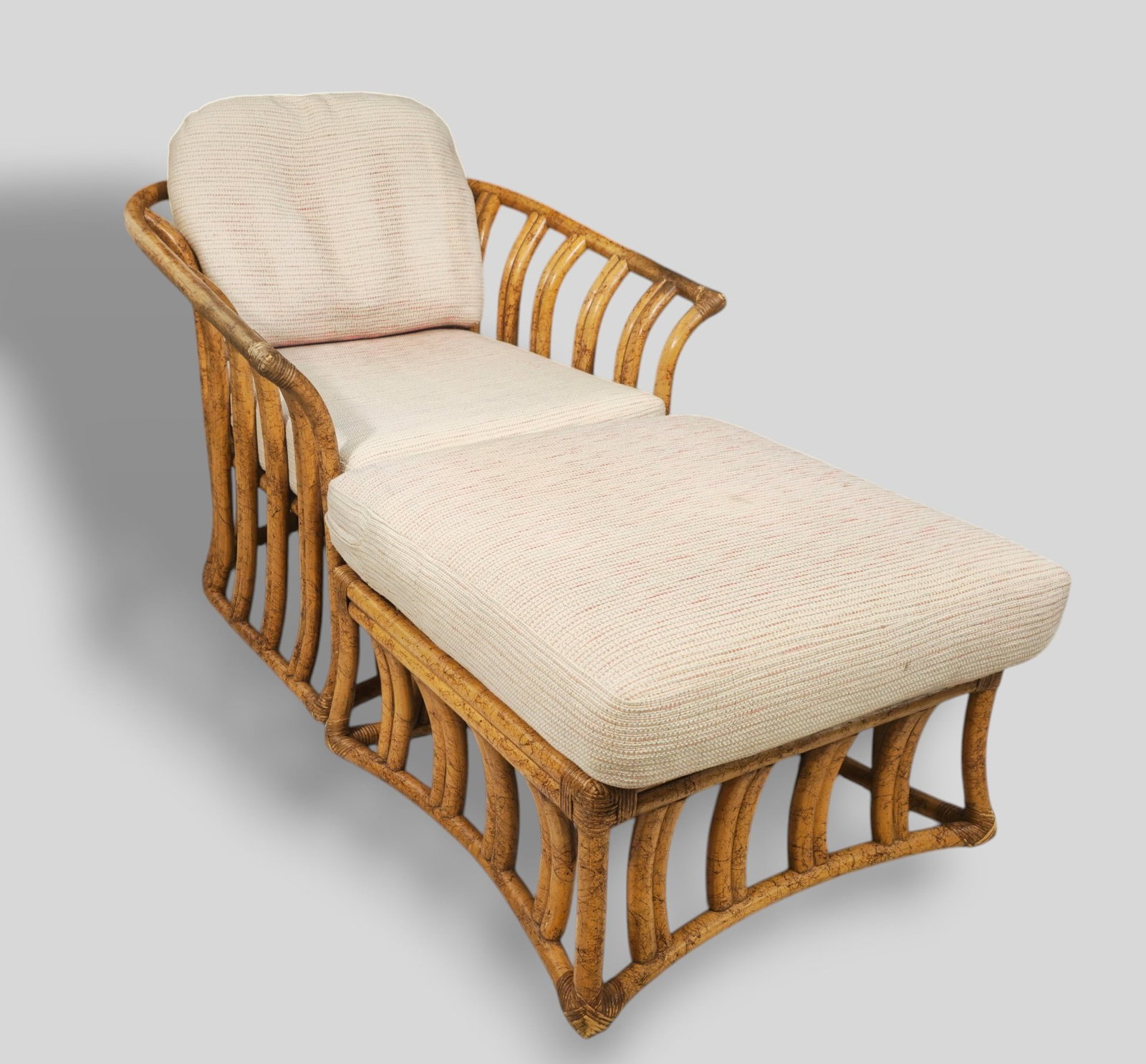 Ficks Reed MCM Bamboo Chair and Ottoman: Ficks Reed MCM Rattan Chair and ottoman. Ficks Reed Inc. USA. 1970s. Rattan and upholstery. Chair - 31w x 35d x 31h, SH -17. Ottoman - 25w x 25d x 17h.