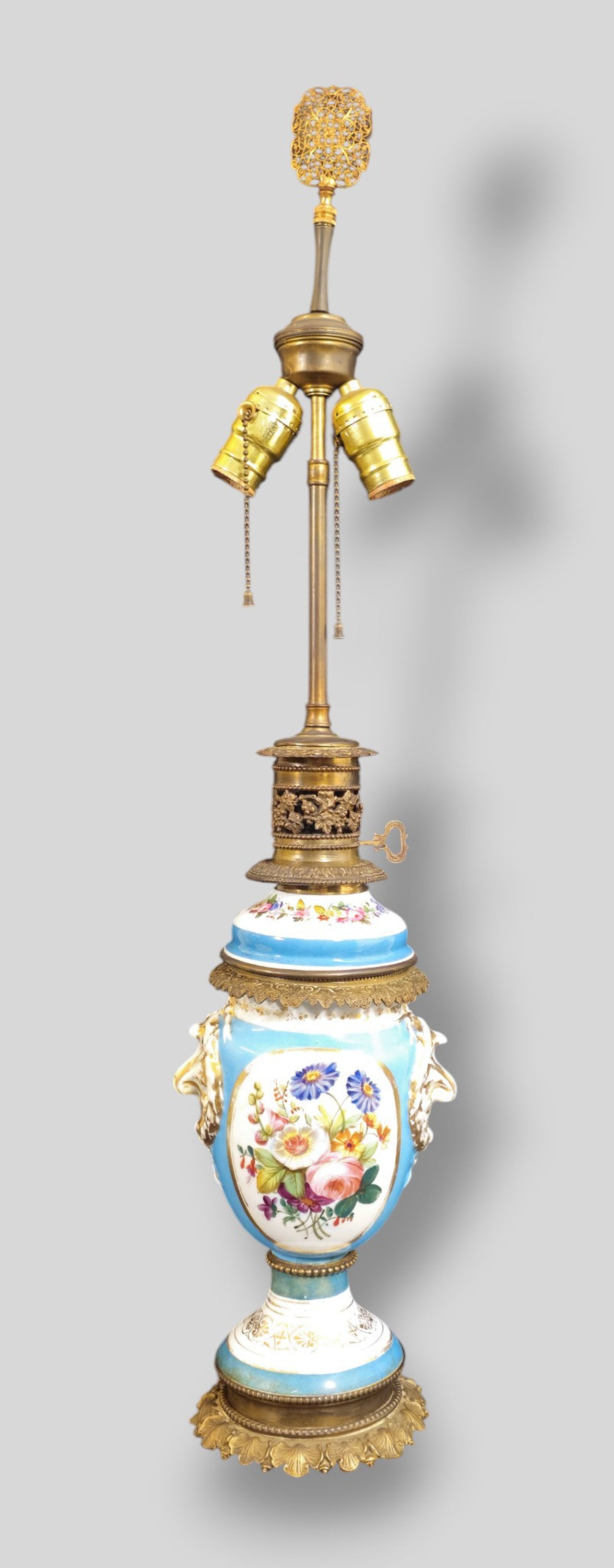 French Sevres Attribution Porcelain Table Lamp: French Sevres Attribution Porcelain Table Lamp. 1920s. Gilt bronze leaf base and borders. Hand painted floral motif and gilt decoration. 7 1/2w x 5 1/2d x 32h. Vase 11 1/2h.