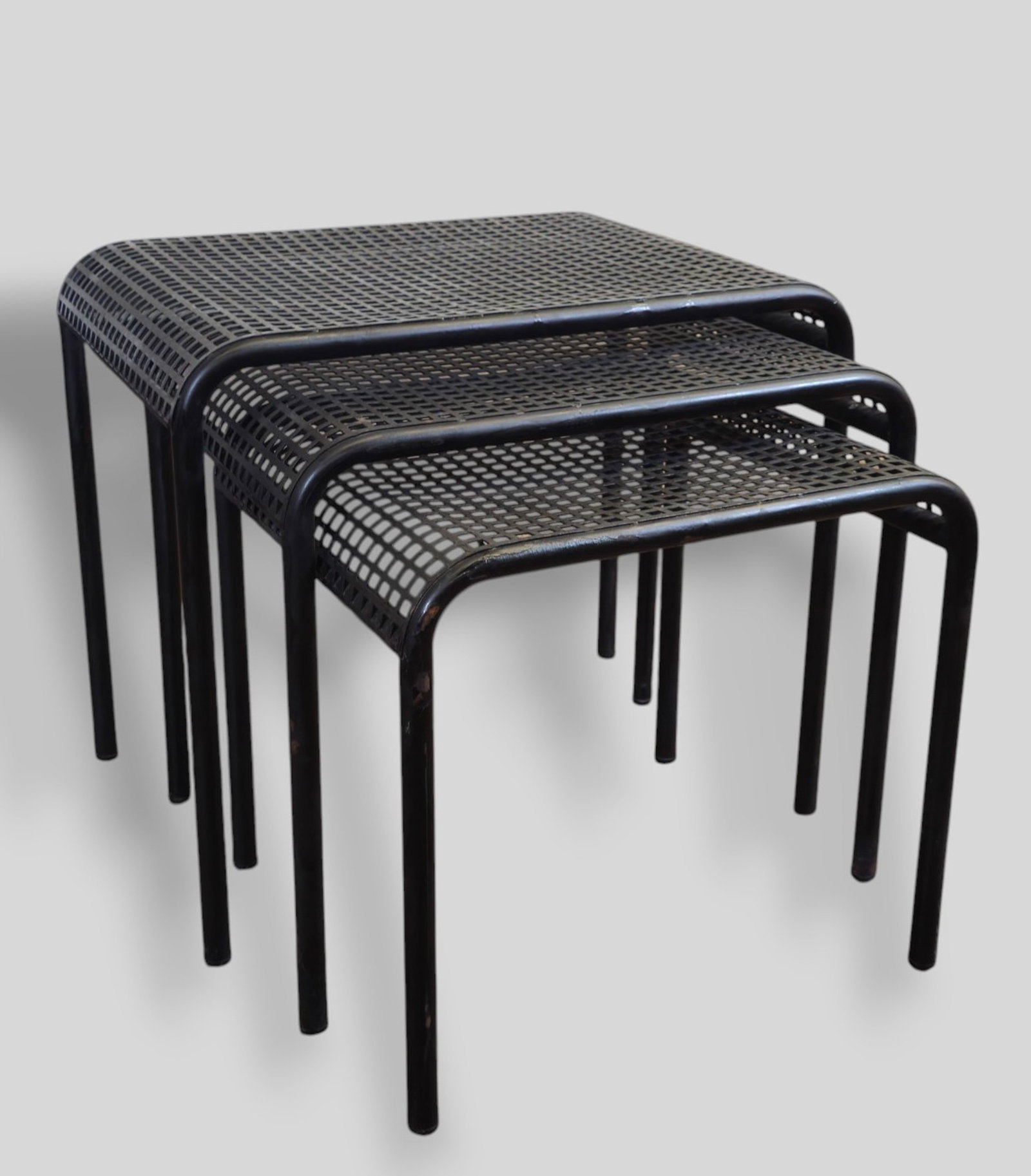 Emilio Narni Postmodern Nesting Tables: Emilio Narni Postmodern Nesting Tables. Flyline. Italy. 1980s. Partial label to underside. Perforated enameled metal. 21 1/4w x 18 1/4d x 18 1/2h.