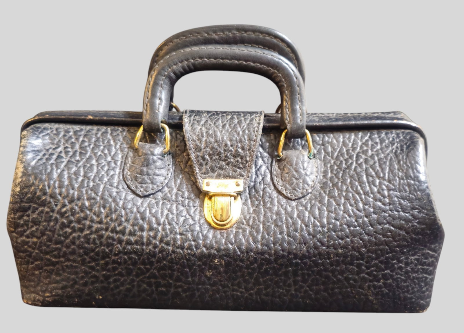 1930s Eli Lilly Leather Doctor's Bag: 1930s Eli Lilly Leather Doctor's Bag. Black pebbled leather and brass clasp manufactured by the Crest Lock Co. Great size. 14w x 5 1/2d x 6h( not including handles)