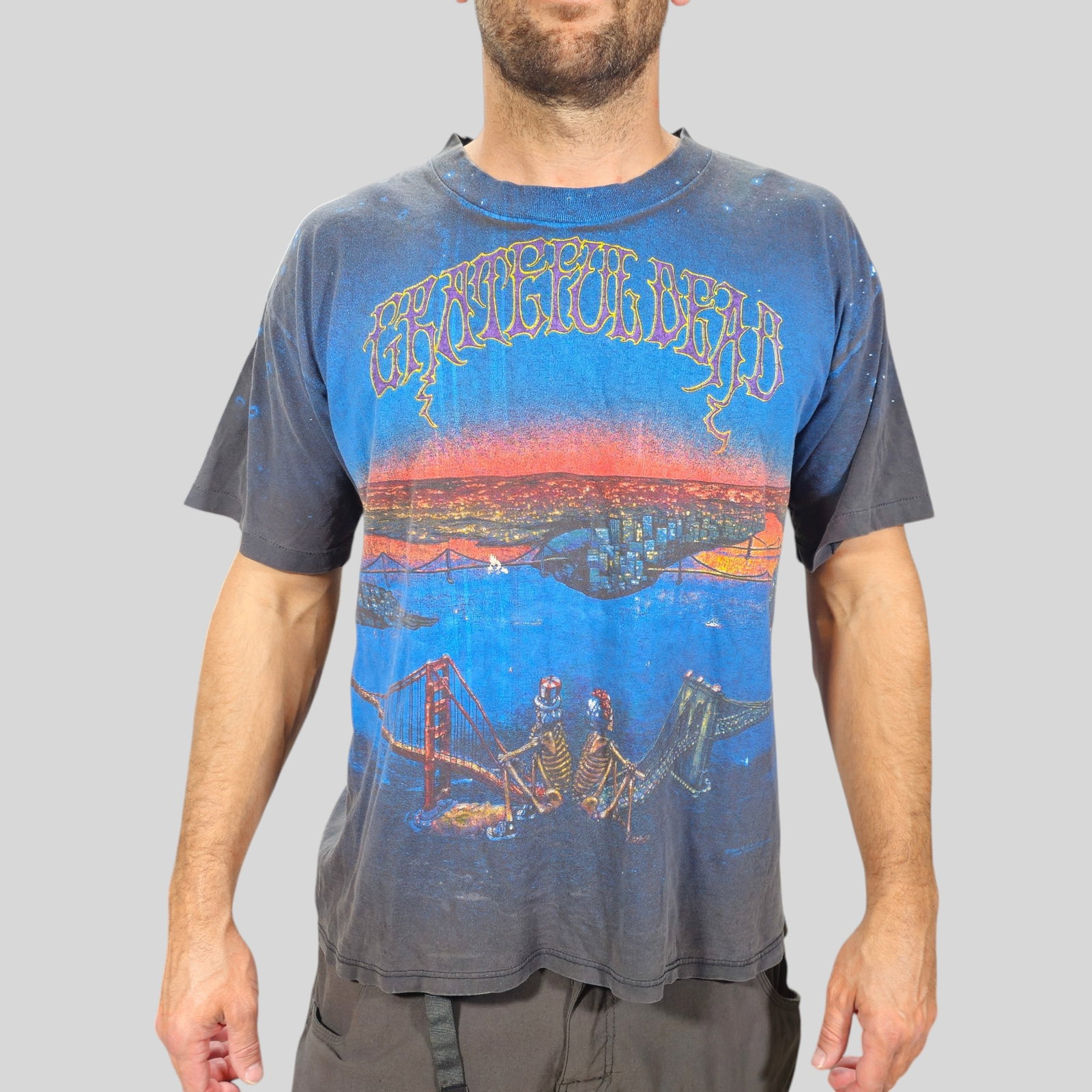 Vintage 1990 Grateful Dead All Over T-Shirt San Francisco & Brooklyn Bridges: Vintage 1990 Grateful Dead All Over T-Shirt San Francisco & Brooklyn Bridges. Single stitch. 100% cotton. Adult large and Wild Oats tag. Graphic is based on the 1981 Dead Set albumn cover. Skeletons o