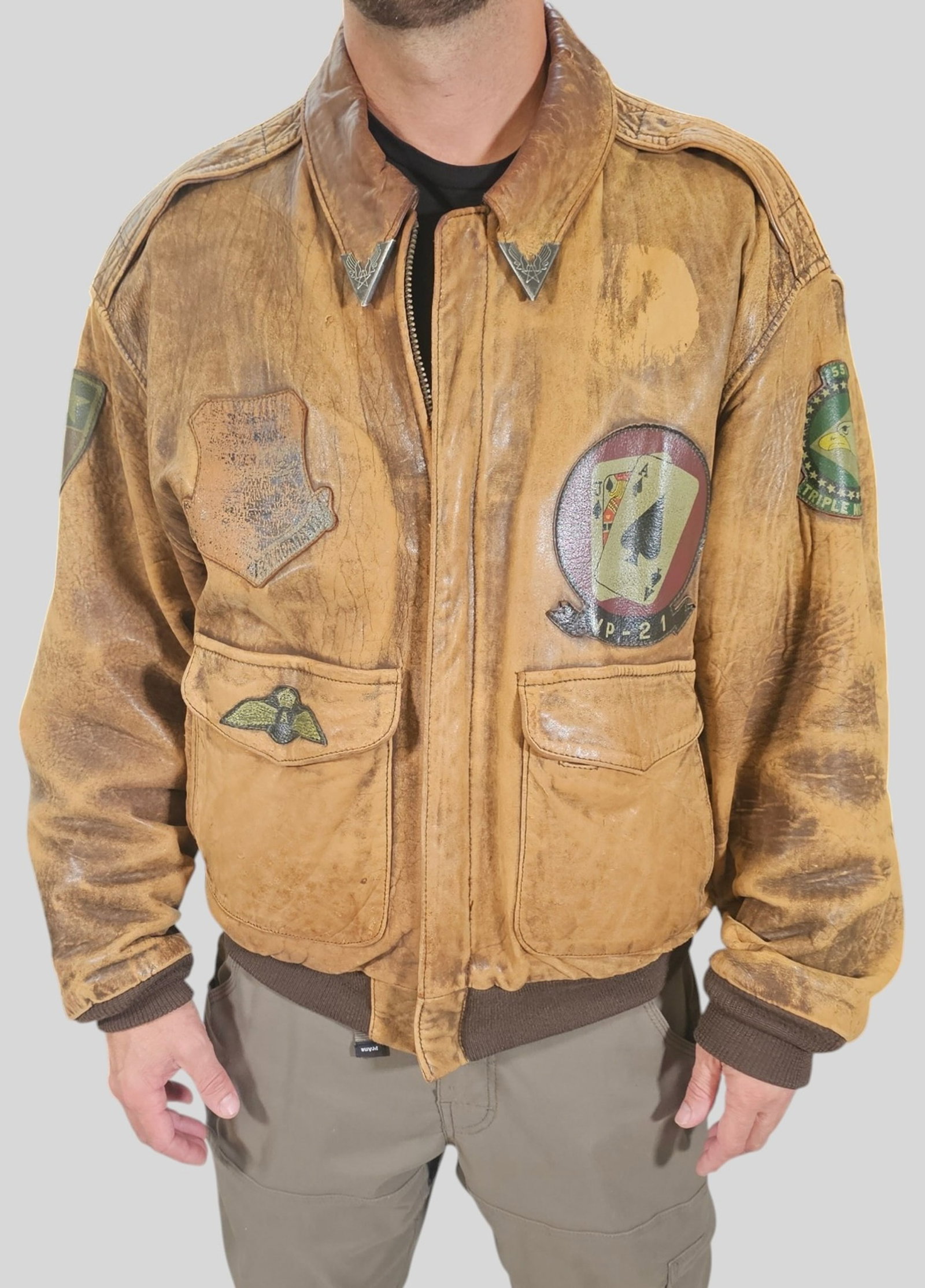 Vintage 1987 Avirex Type A-2 Flight Jacket: Vintage 1987 Avirex Type A-2 Flight Jacket. Brown leather with aged patina. Card suit motif patch and map pattern interior liner. Vintage Adult size Xtra large. Partial label. Shoulder to Shoulder 21.