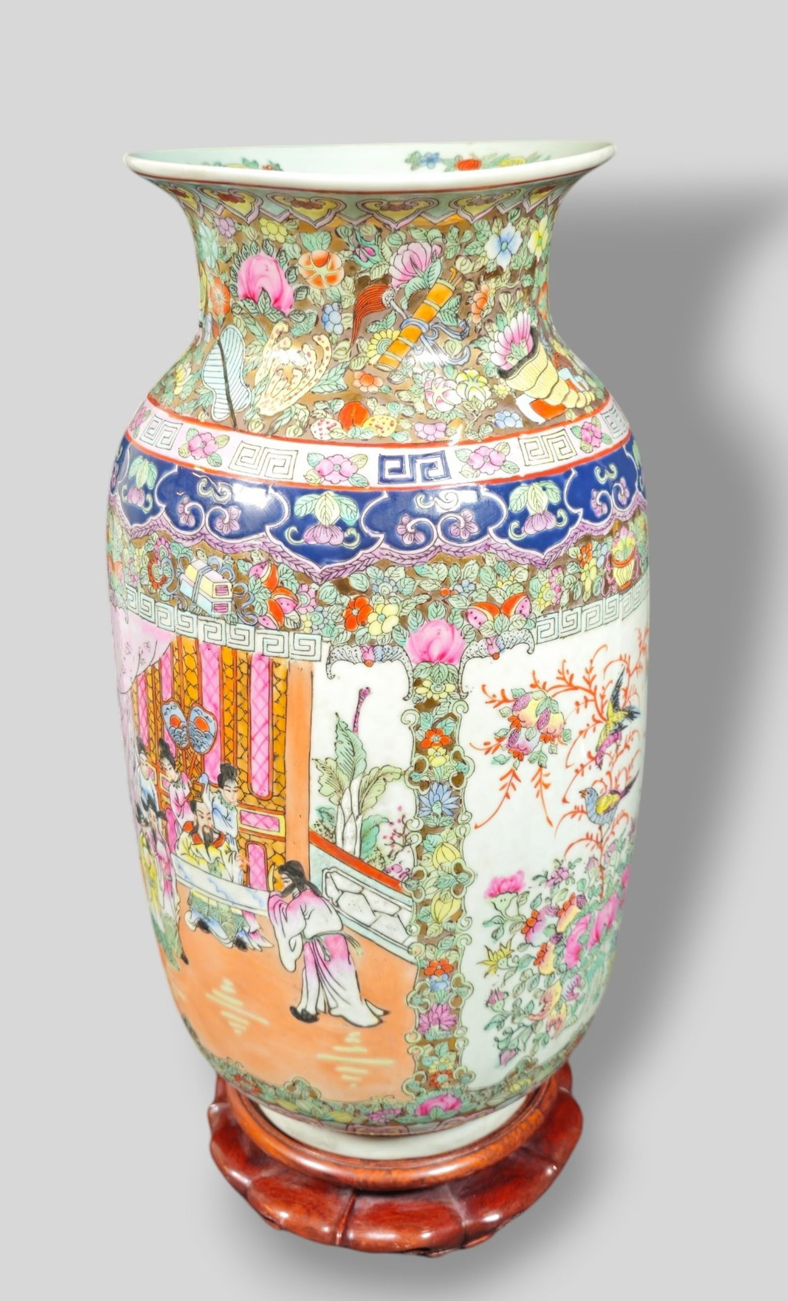 Chinese Qianlong Dynasty Style Large Porcelain Rose Medallion Vase: Chinese Qianlong Dynasty Style Large Porcelain Rose Medallion Vase. Decorated with figures in palace settings, floral motif and birds. Carved teak lotus form base. Vase 9dia x 18 1/8h. Base 7 1/2 dia 