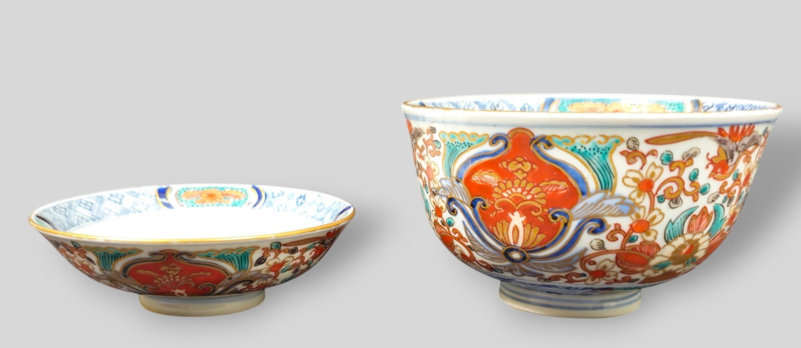 19th Century Japanese Meiji Period Porcelain Bowls: 19th Century Japanese Meiji Period Porcelain Bowls. Rice bowl 4 5/8dia x 2 3/4h. Shallow bowl on teak stand. Bowl 4 1/8dia x 1 1/4h. Each signed to underside and have floral motif.