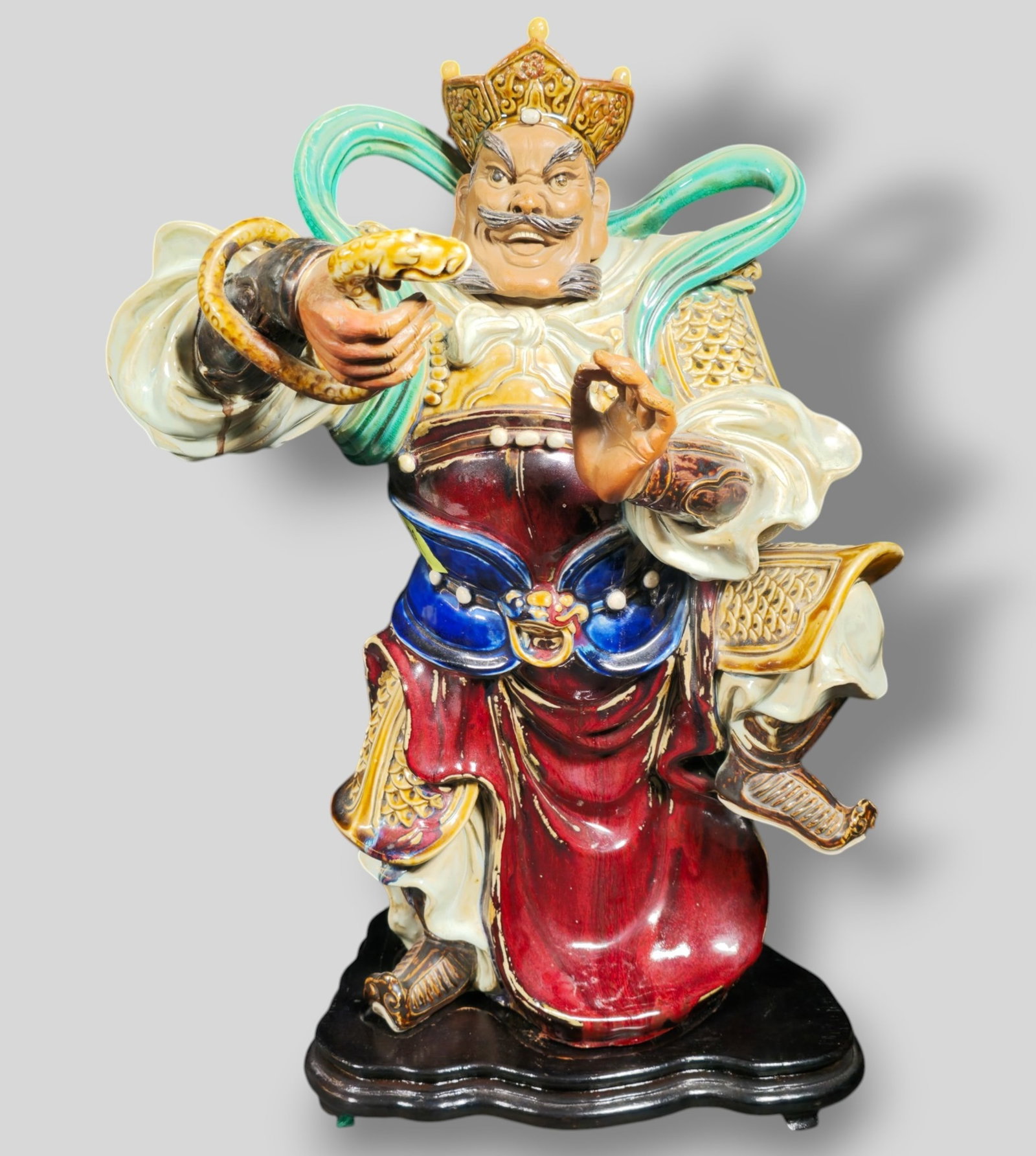 Chinese Guan Gong God of War Porcelain Figure: Chinese Guan Gong God of War Porcelain Figure. 20th Century. Raised on fitted teak base. 17w x 9d x 22 1/2h.