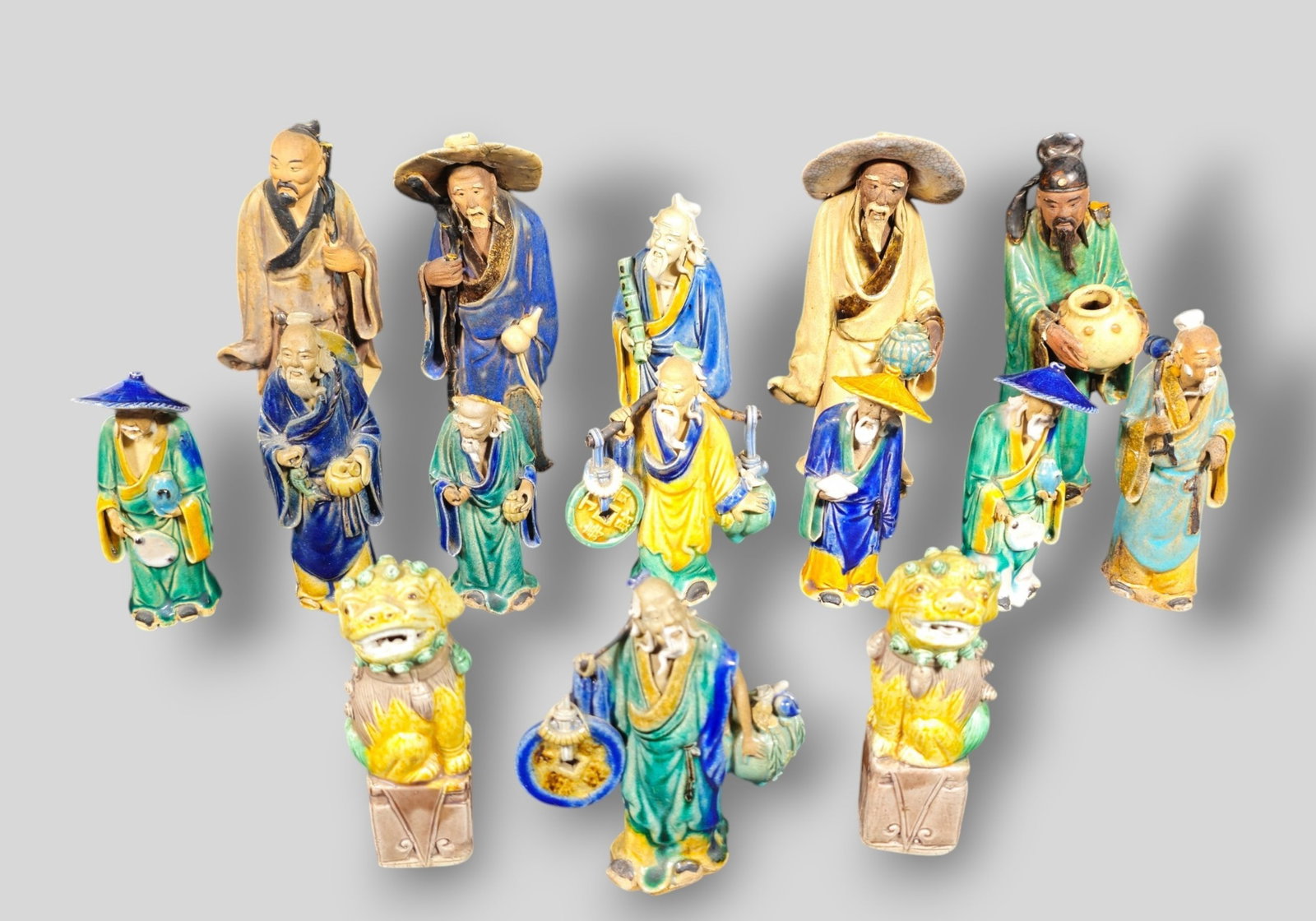 Assembled 19th and 20th Century Chinese Mud Men and Foo Dogs: Assembled 19th and 20th Century Chinese Mud Men and Foo Dogs. 15 Various mud men and a pair of foo dogs. Excellent glazes. Stamped China or have red glaze China to underside. Tallest 3 1/4w x 2 1/2d