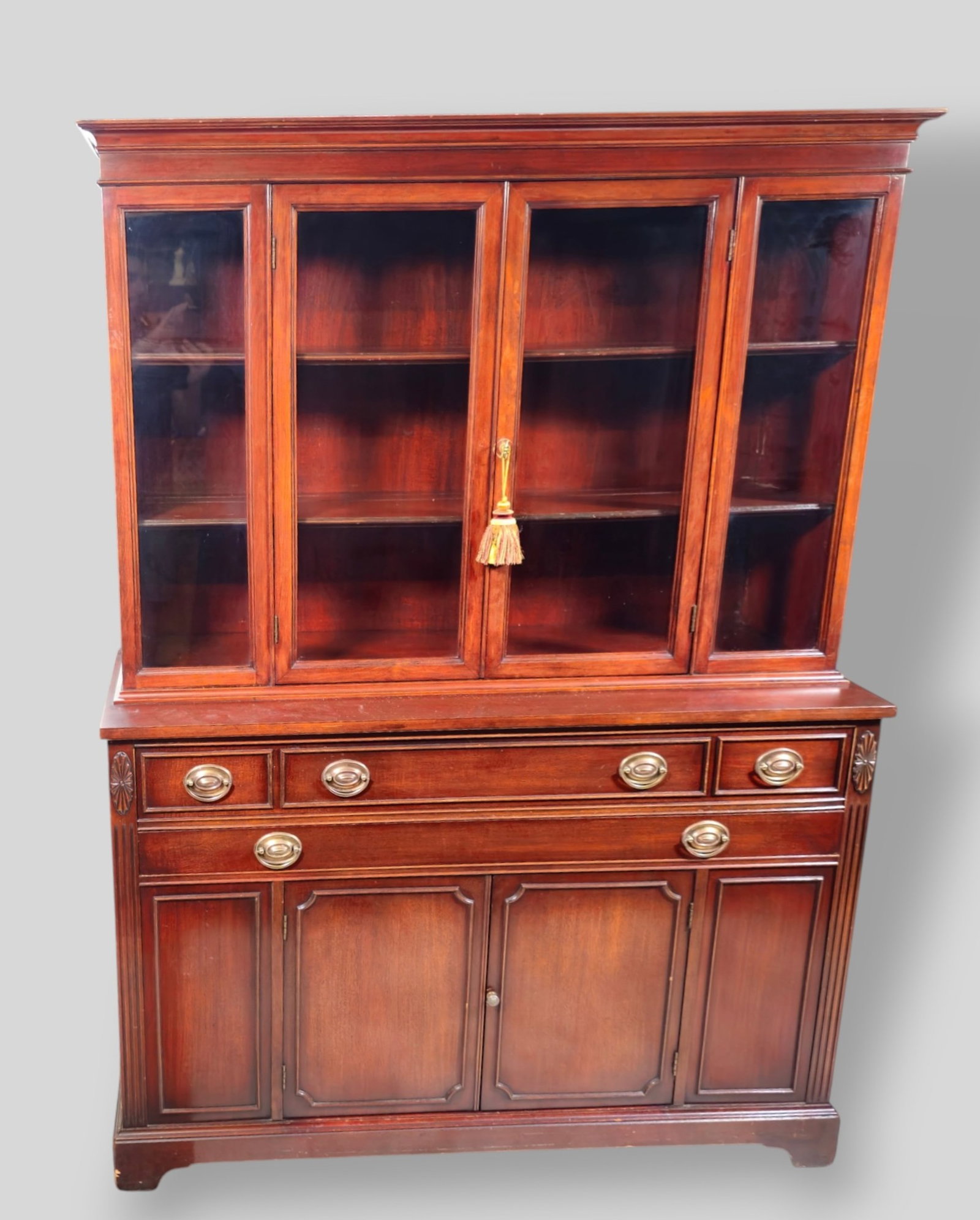 Mahogany Georgian Style China Cabinet: Mahogany Georgian Style China Cabinet. Cove molded top over two glass doors and glass panels. Base has 2 long drawers over 2 center drawers. Original brass hardware. 52w x 18d x 70 1/2h.