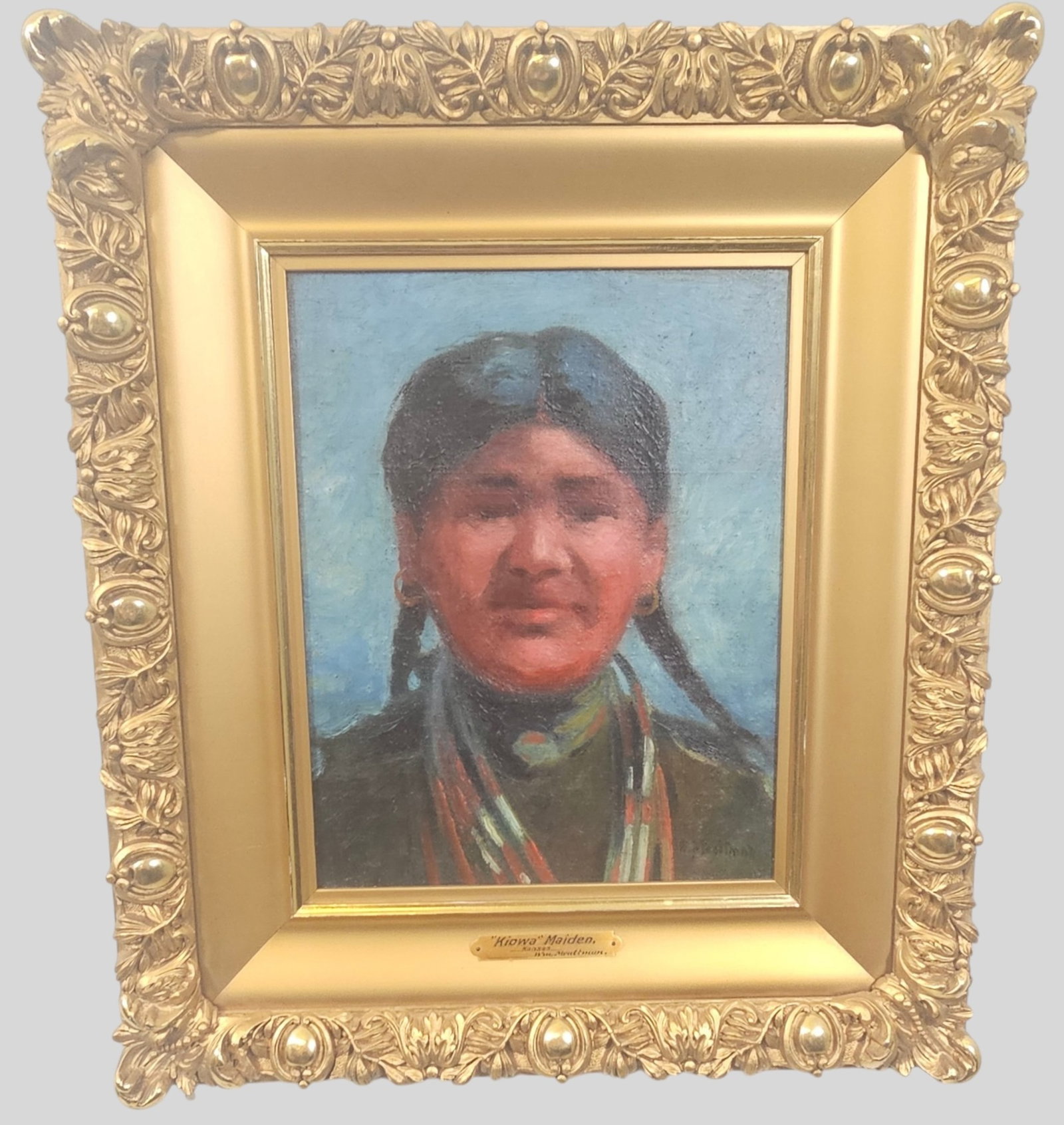William Meuttman Oil: William Meuttman (1869-1948, American) Oil on canvas, "Kiowa" Maiden. Signed lower right. Housed in fine gilt carved frame. Sight 11 1/2 x 9. Frame 19 1/2 x 17.