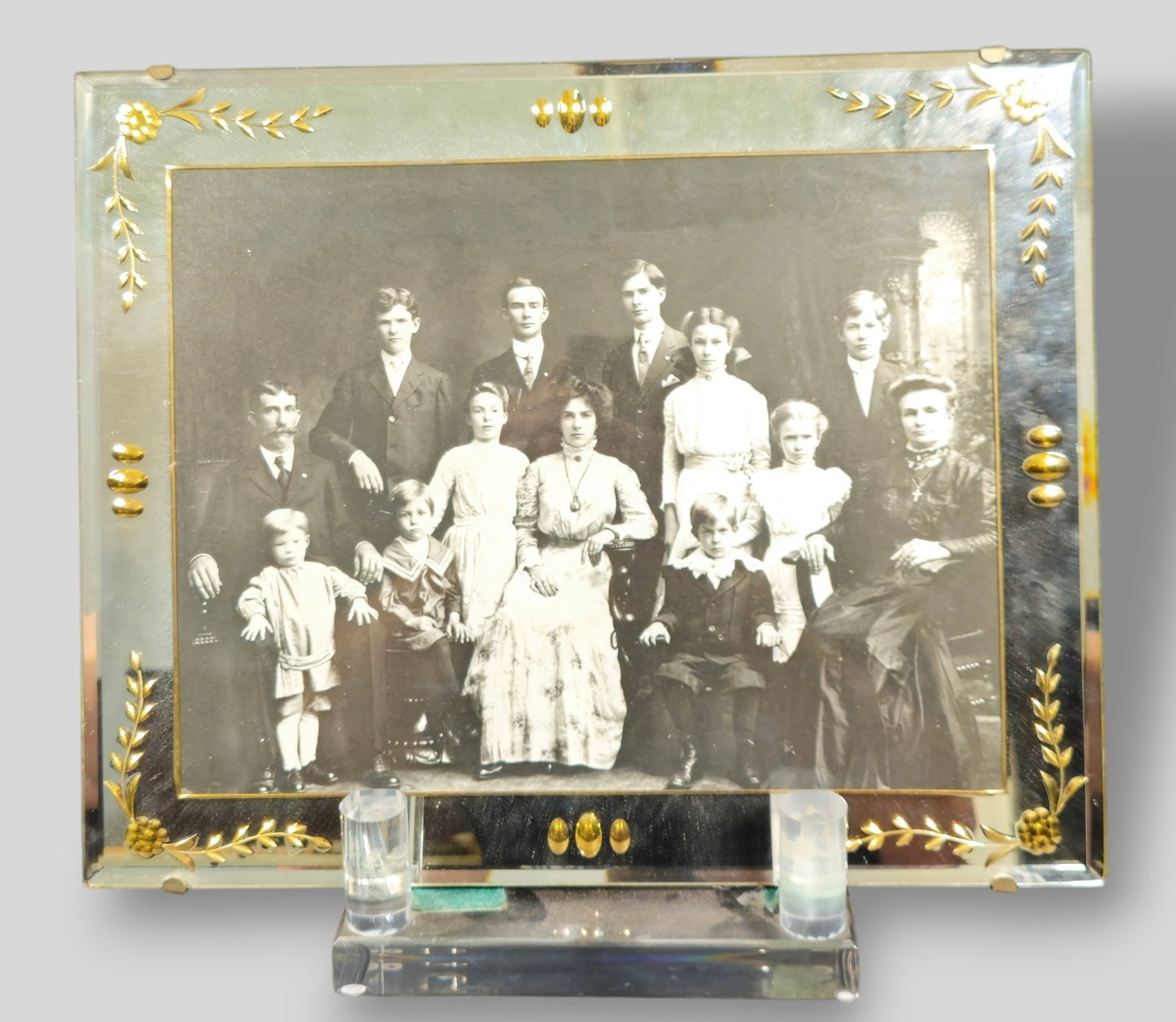 1900 Family Portrait Frame in Etched Mirrored Frame: 1900 Family Portrait Frame in Etched Mirrored Frame. Etched and gilded floral motif. Frame 16w x 1/4d x 13h. Acrylic plate rack is not included.