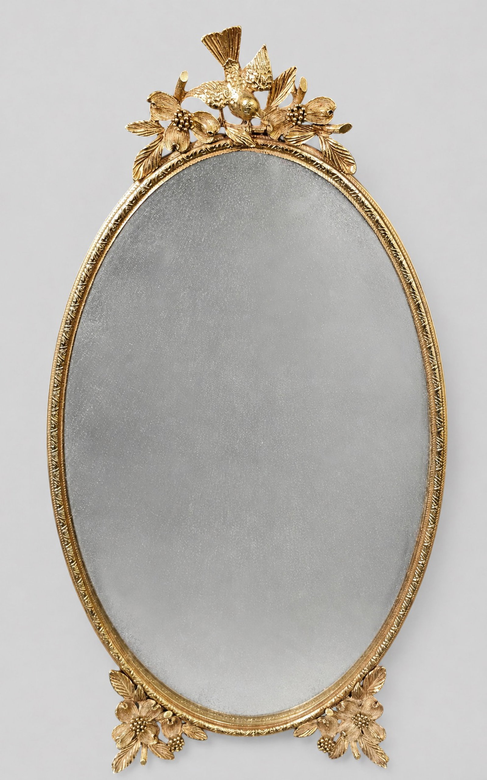 Gold Gilt Vanity Mirror with High Relief Bird and Blackberry Branches: Gold Gilt Vanity Mirror with High Relief Bird and Blackberry Branches. Circa 1950. Oval mirror. 7 1/8w x 1 1/4d x 14h.