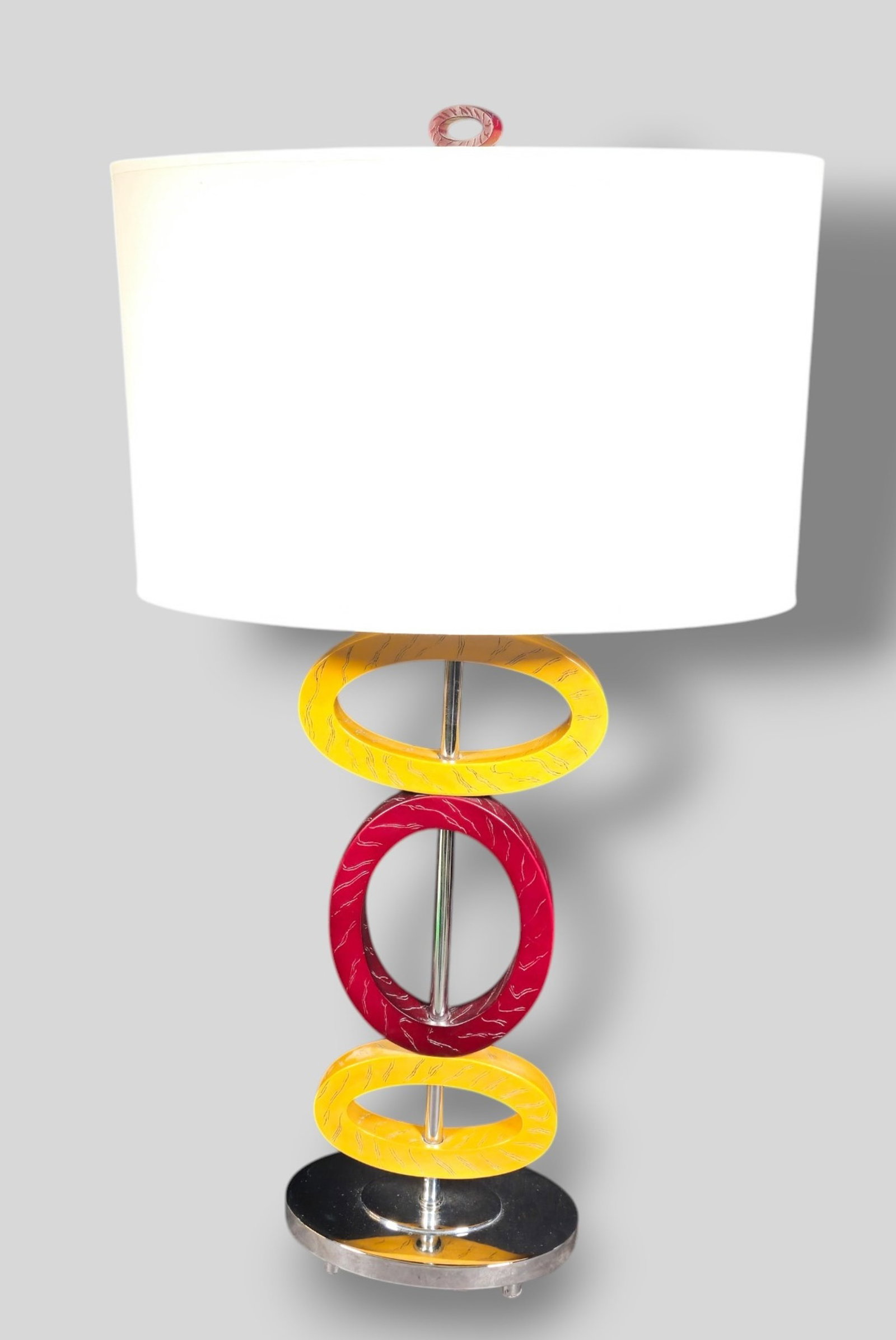 Contemporary Chrome and Cast Resin Table Lamp: Contemporary Chrome and Cast Resin Table Lamp. 1990s. 3 rings on oval base. Lamp 8w x 5d x 29 1/4h. Overall 15 5/8w x 8 1/4d x 29 1/4h.