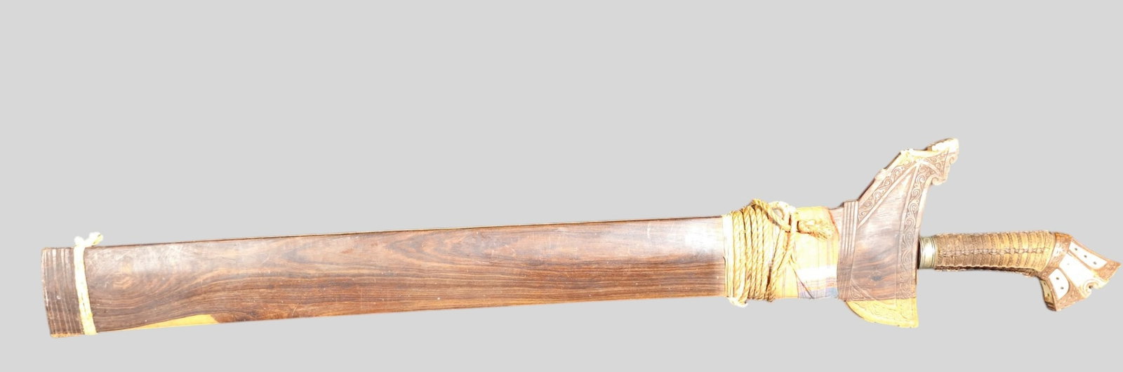 Filipino Moro Sundang Kris Sword Late 19th Century: Filipino Moro Sundang Kris Sword Late 19th Century. Double edged wavy blade with hardwood, copper alloy and silver inlay. Original but loose rosewood scabbard. Blade 23 long x 2w. Etched and engraved 