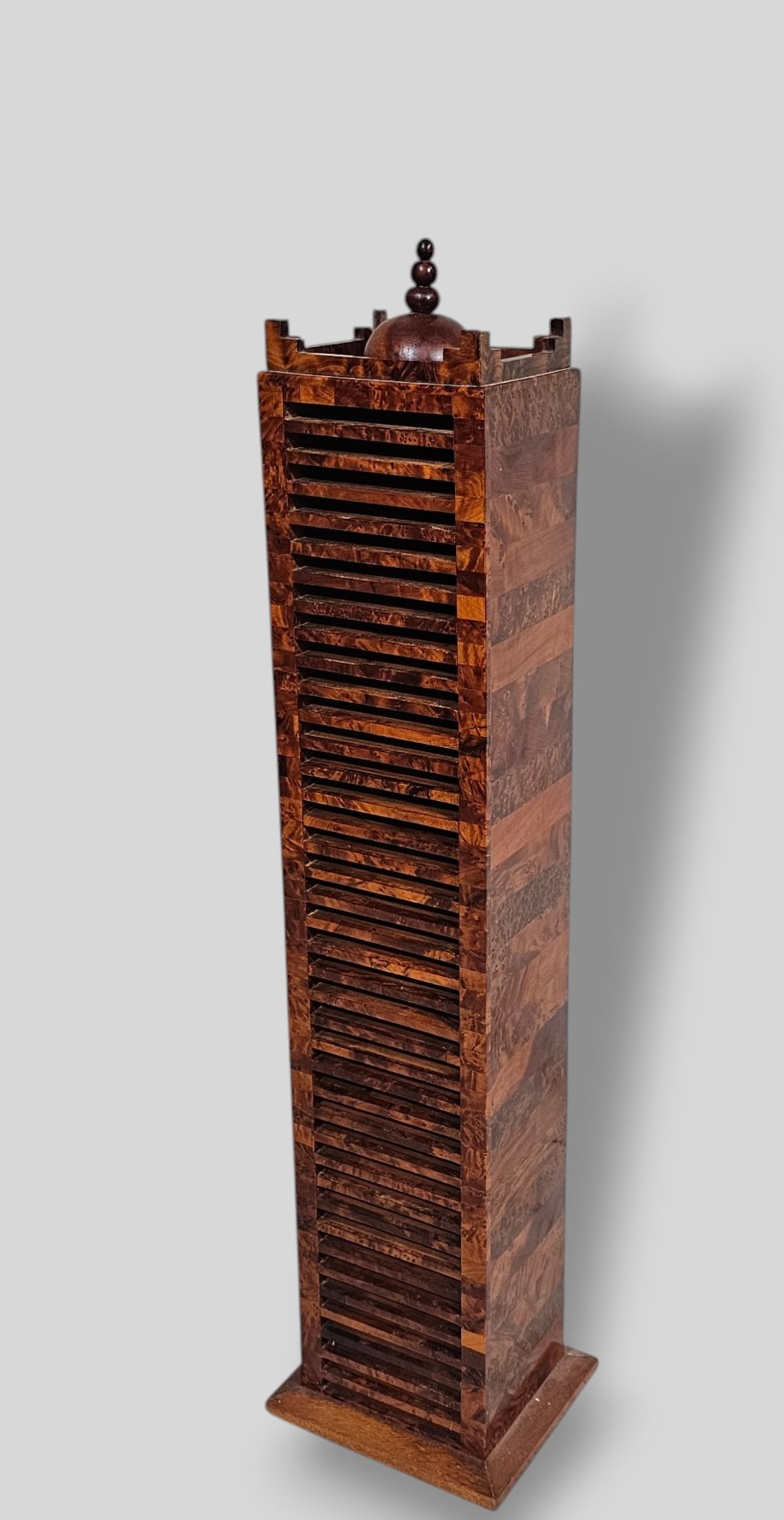 Burlwood Stand: Burlwood Stand. 20th Century. Exotic burlwood. Turned finial and geometric gallery. 40 slots. 8 1/2w x 7 1/4d x 36 1/2h.