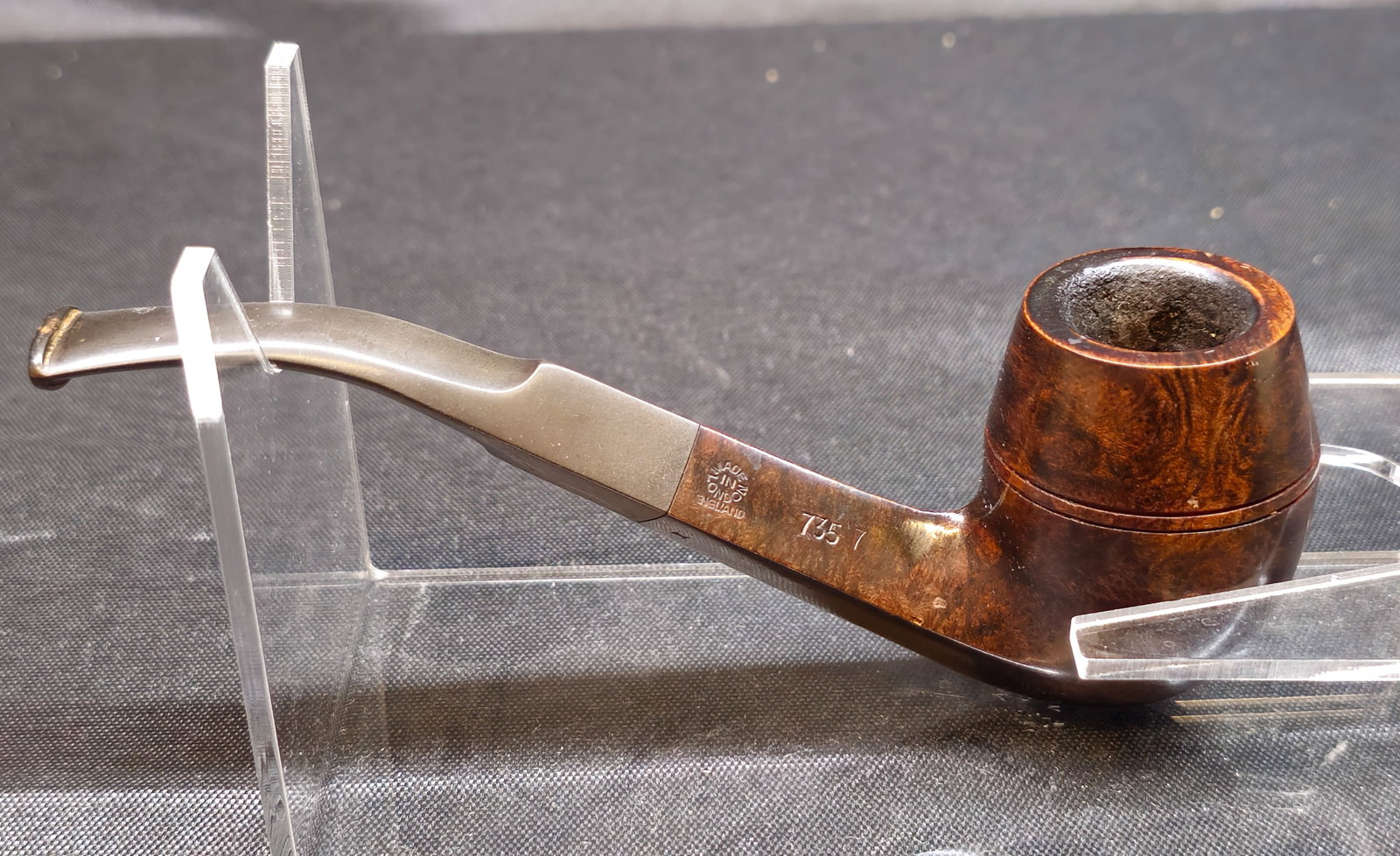 Comoy's Made In London 7357 Bent Bulldog Pipe: Comoy's briar tobacco pipe in a classic bent Bulldog form, marked H, Made in London England, and 7357 to the shank, with the Comoy's C logo to the mouthpiece. A handsome English-made estate pipe with