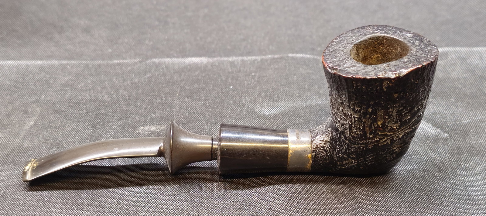 Savinelli Nonpareil 99 Sterling Silver Banded Billiard Pipe: Savinelli Nonpareil briar tobacco pipe in a classic Billiard form, marked with the Savinelli "S," shape number 99, and Italy. Accented with a sterling silver band to the shank. Manufacturer's mark to