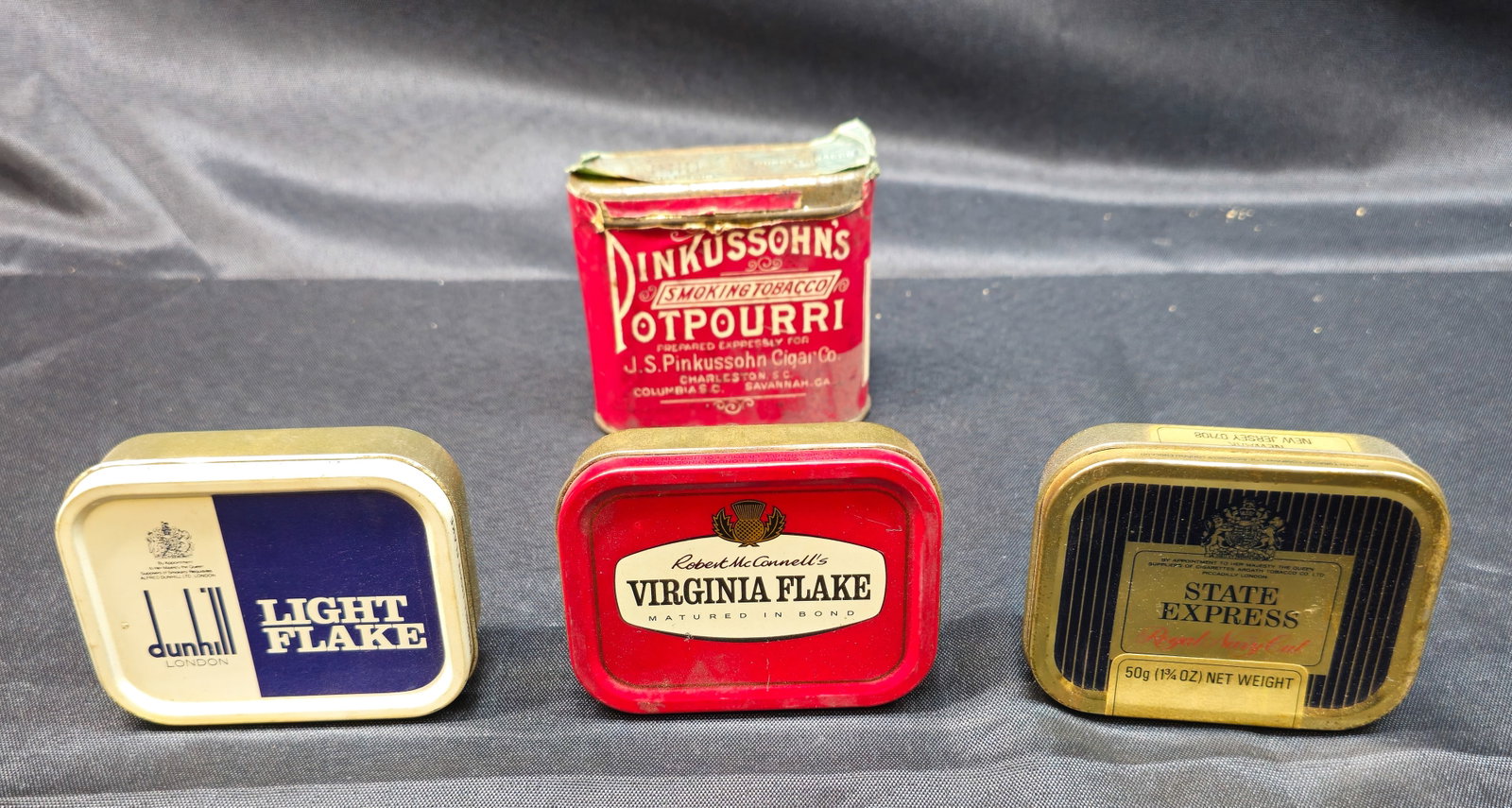 Vintage Tobacco & Advertising Tins: Vintage Tobacco & Advertising Tins. Lot of four tobacco tins including Dunhill Light Flake, Robert McConnell's Virginia Flake, State Express Royal Navy Cut, and J.S. Pinkussohn Potpourri Smoking
