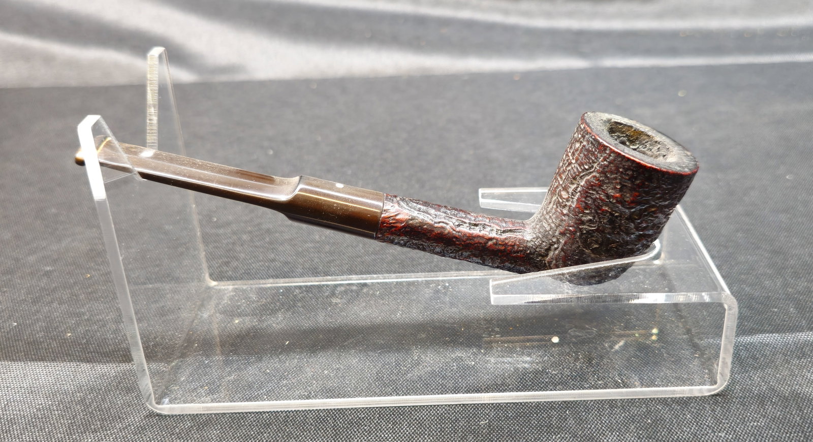 Dunhill Shell Briar 6142: Dunhill Shell Briar 6142. English briar tobacco pipe with dark sandblasted finish and straight stem. Stamped "6142 Dunhill Shell Briar Made in England 4S." Manufacturer’s mark to pipe.