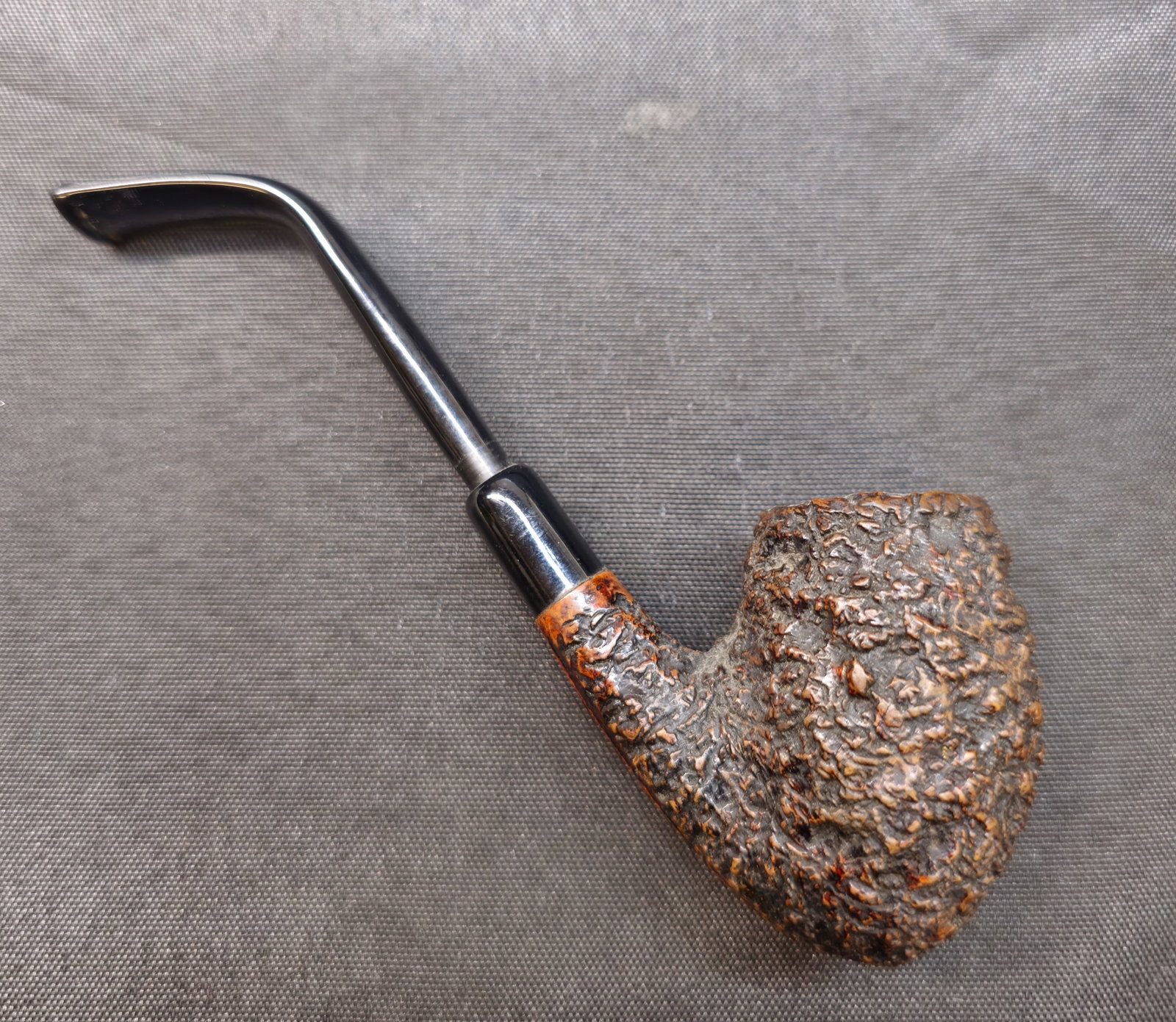 Castello Sea Rock Briar KKKK: Castello Sea Rock Briar KKKK. Italian briar tobacco pipe with deeply rusticated finish, bent form and black mouthpiece. Stamped "Castello Sea Rock Briar," "Made in Cantu Italy," "Carlo Scotti" and