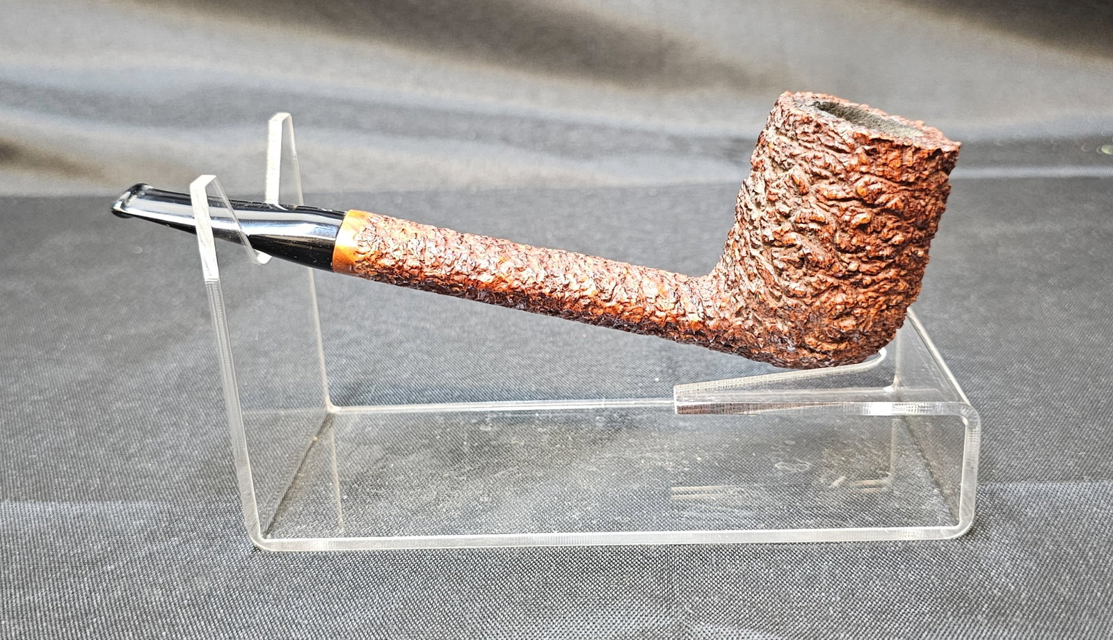 Brugo Prima 1993 Fatta a Mano: Brugo Prima 1993 Fatta a Mano. Italian briar tobacco pipe with deeply rusticated finish, straight shank and black mouthpiece with decorative inlaid emblem. Stamped "BRUGO Prima 1993," "ITALY," and