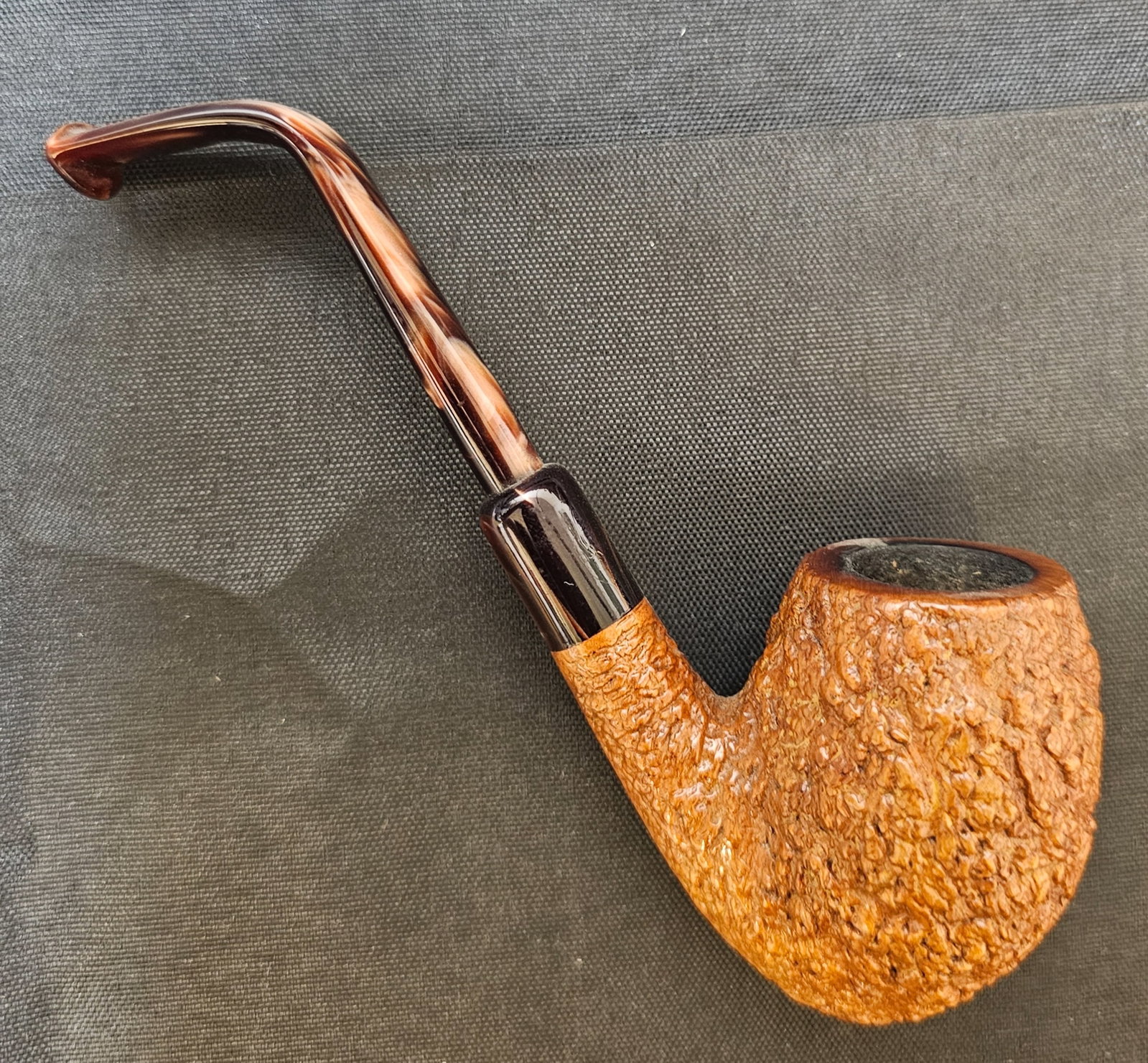 Castello Old Sea Rock KKKK 93 Pipe: Castello Old Sea Rock KKKK 93 Pipe. Italian briar tobacco pipe with rusticated finish, bent shape and variegated brown mouthpiece. Stamped "CASTELLO OLD SEA ROCK," "KKKK 93," "MADE IN CANTU ITALY,"