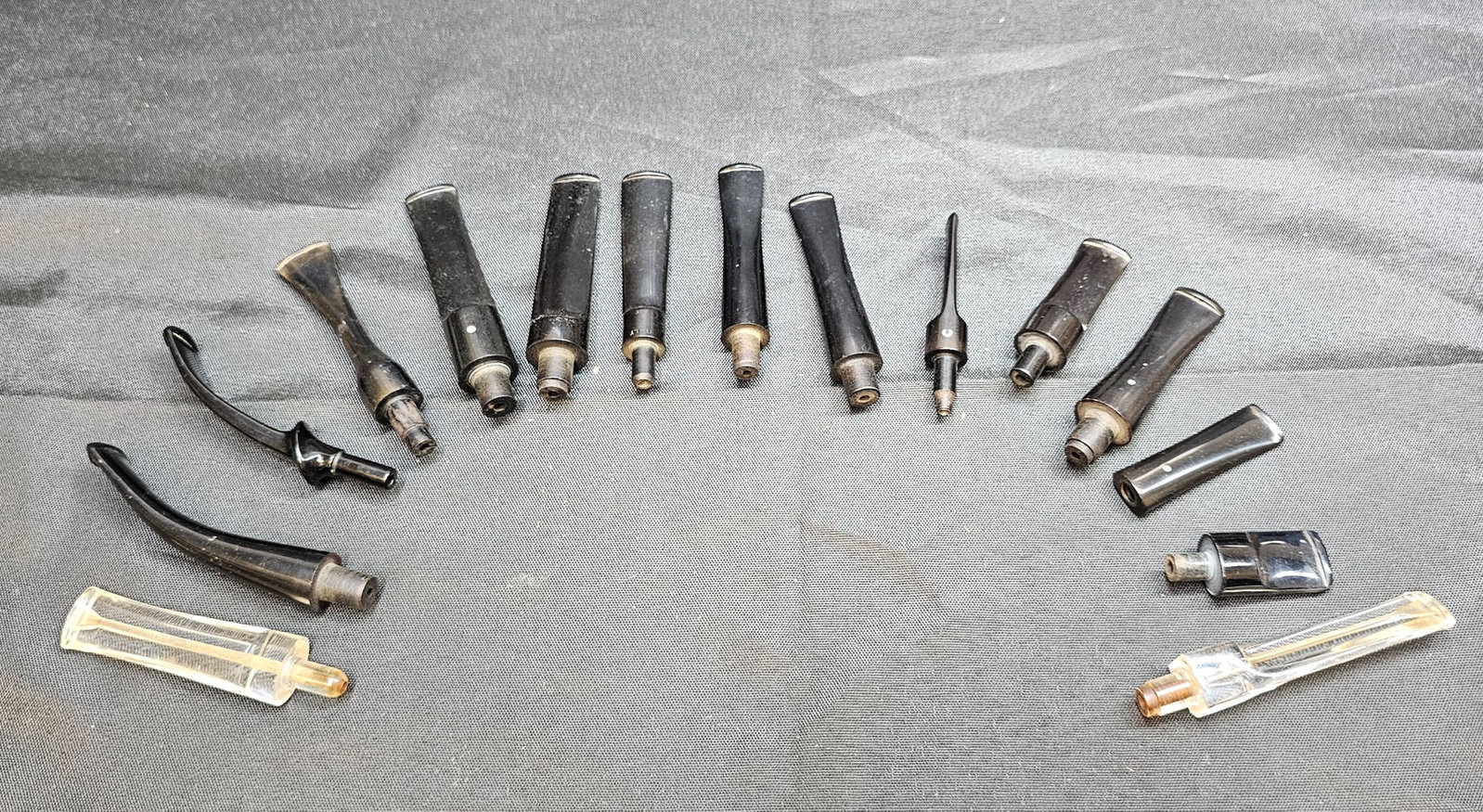 Assorted Tobacco Pipe Stems and Mouthpieces: Assorted Tobacco Pipe Stems and Mouthpieces. Group of approximately 16 assorted loose tobacco pipe stems and mouthpieces in various sizes and configurations, including straight, bent, saddle and