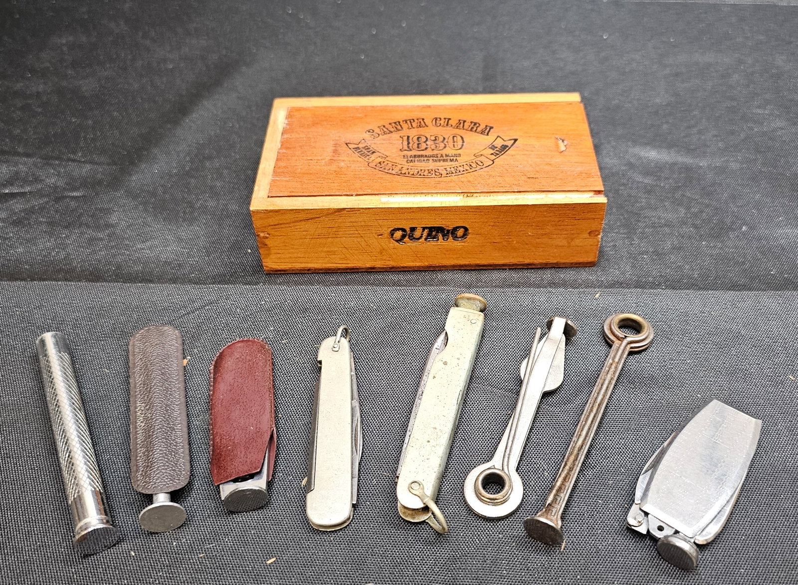 Assorted Tobacco Pipe Tools in Santa Clara 1830 Cigar Box: Assorted Tobacco Pipe Tools in Santa Clara 1830 Cigar Box. Collection of eight assorted tobacco pipe maintenance tools including tampers, reamers, scrapers, picks and combination folding tools, housed