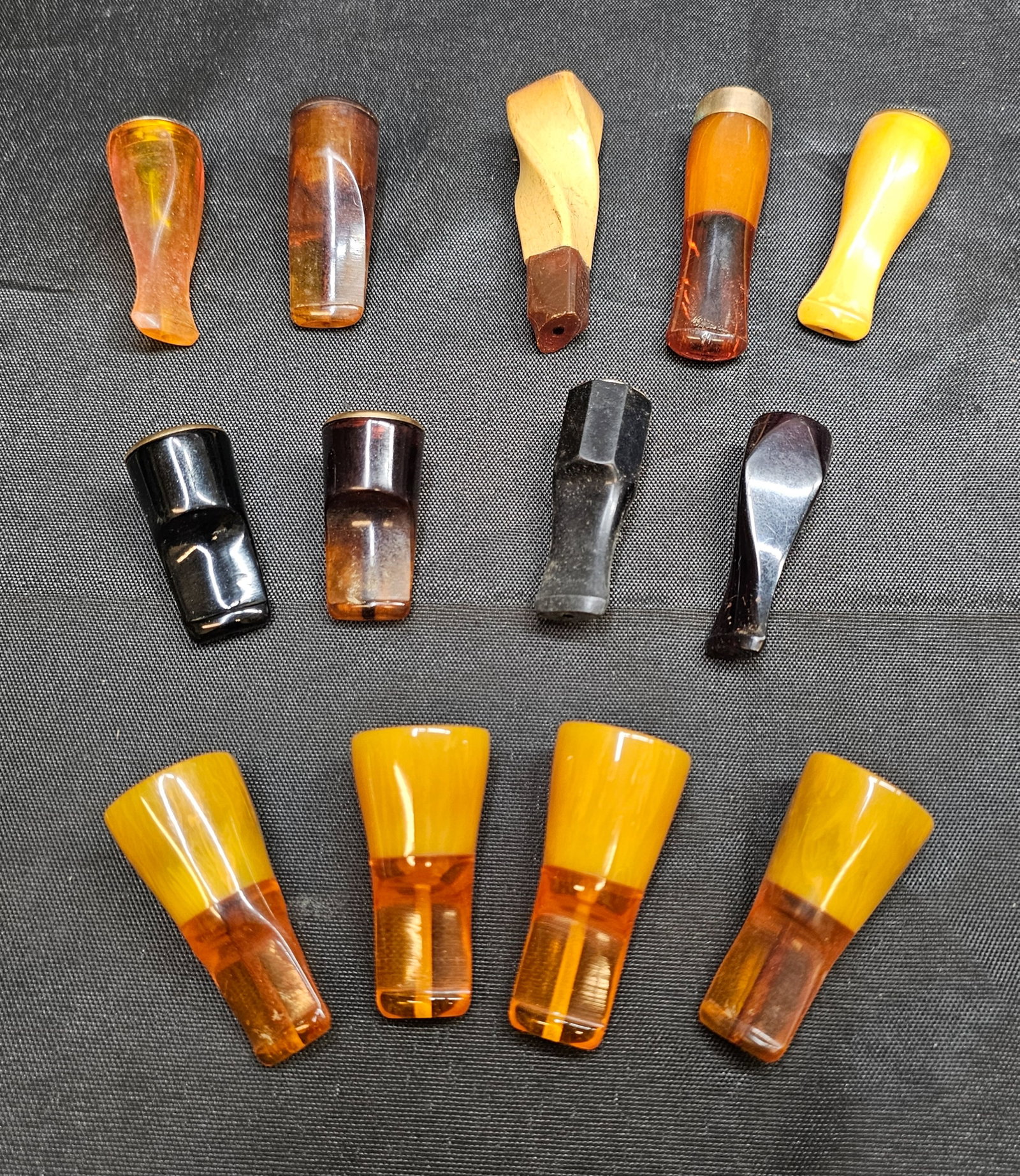 Assorted Tobacco Pipe Stems & Mouthpieces: Assorted Tobacco Pipe Stems & Mouthpieces. Collection of 13 assorted replacement tobacco pipe stems and mouthpieces in amber, yellow, brown and black finishes, including translucent and opaque