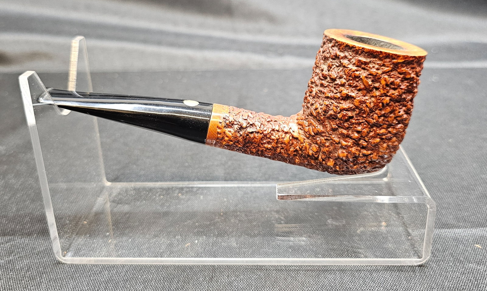 Brugo Mastro de Paja Media OC Pipe: Brugo Mastro de Paja Media OC Pipe. Italian briar tobacco pipe in a straight billiard shape with a warm brown rusticated finish, smooth rim and stamping panel, and black stem with inset round logo.