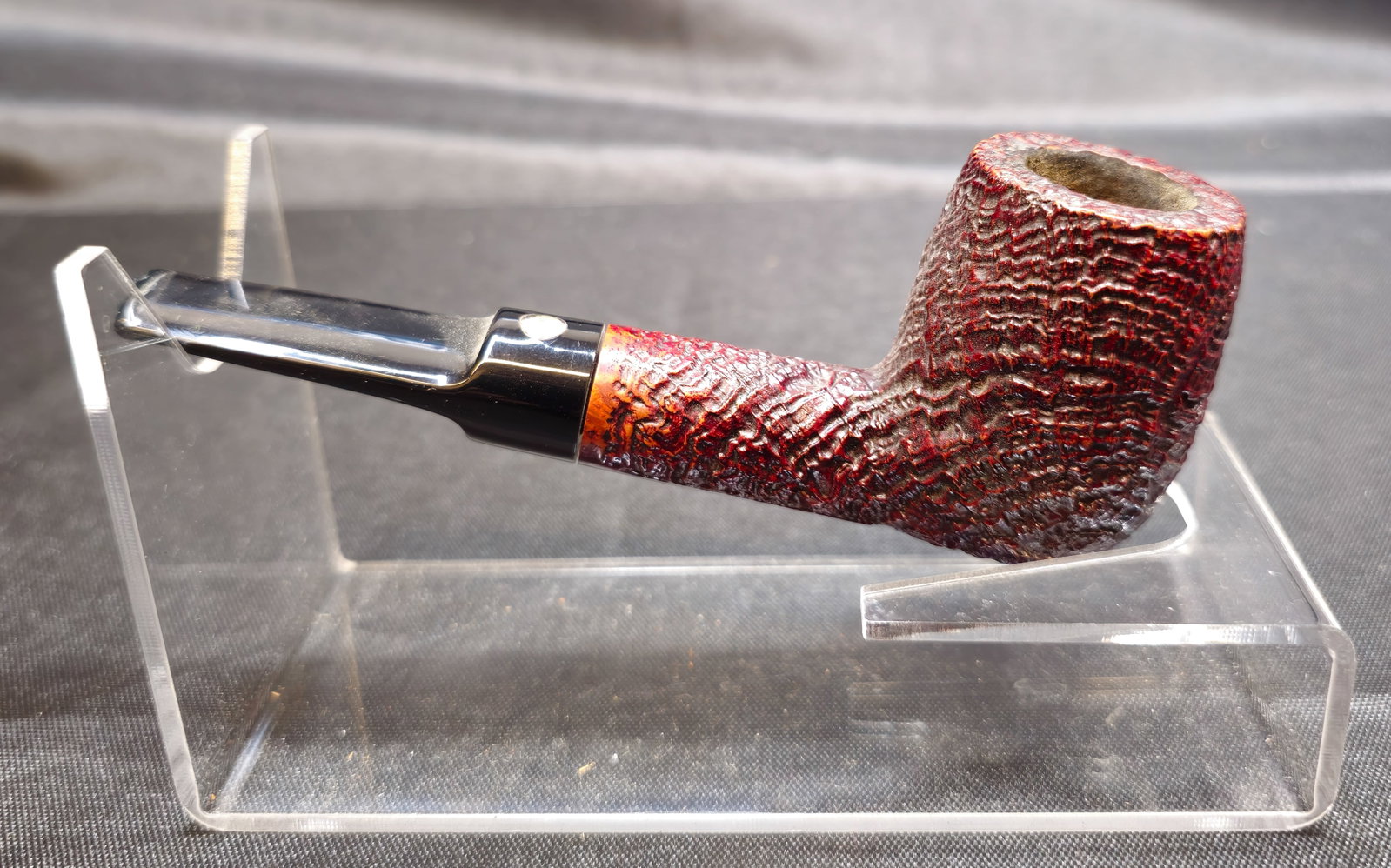 Mastro de Paja 1B Pipe: Mastro de Paja 1B Pipe. Italian briar tobacco pipe in a straight Dublin shape with deep rusticated finish in dark red and black tones, smooth stamping panel, and black stem with inset round logo.