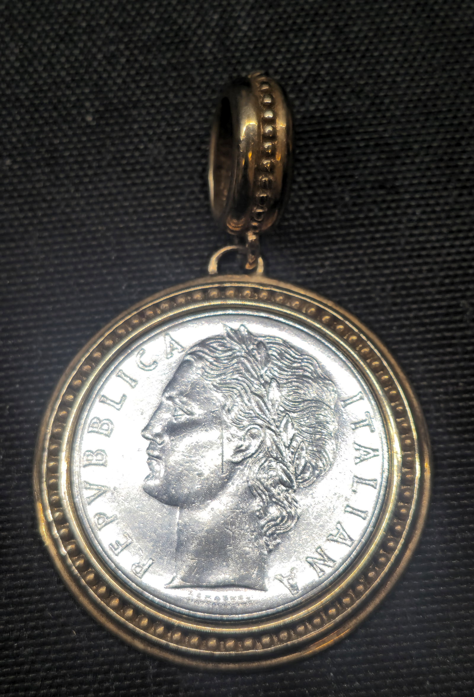 Italian 925 Sterling Silver 100 Lire Coin Pendant: Italian 100 Lire coin pendant featuring a Republica Italiana design, mounted within a decorative gold-tone sterling silver bezel with beaded border and large bail. Bezel marked “925 ITALY.” Co