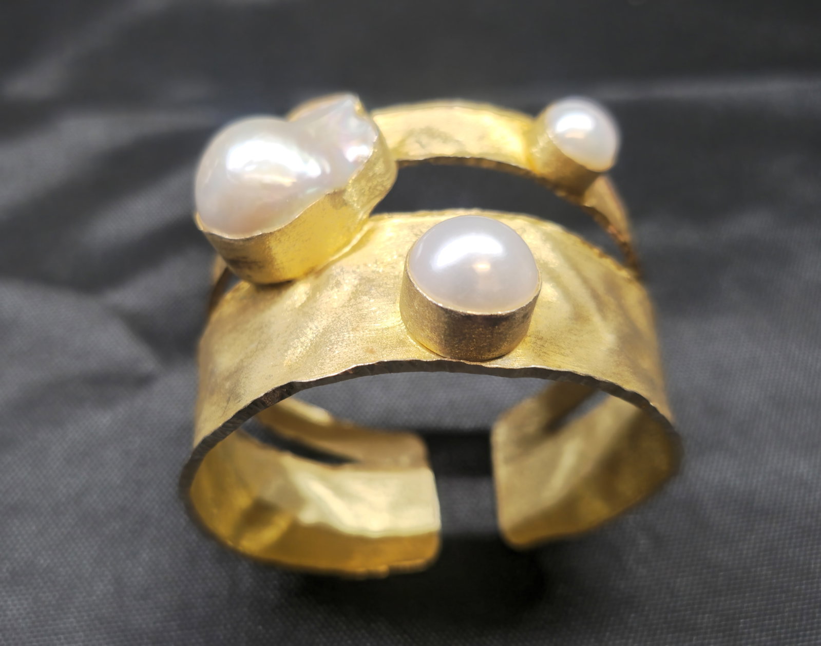 JS Gold Vermeil Sterling Silver & Pearl Cuff Bracelet: JS gold vermeil sterling silver open cuff bracelet of sculptural hammered design, accented with cultured freshwater pearls including an irregular baroque pearl. Marked “JS 925.”