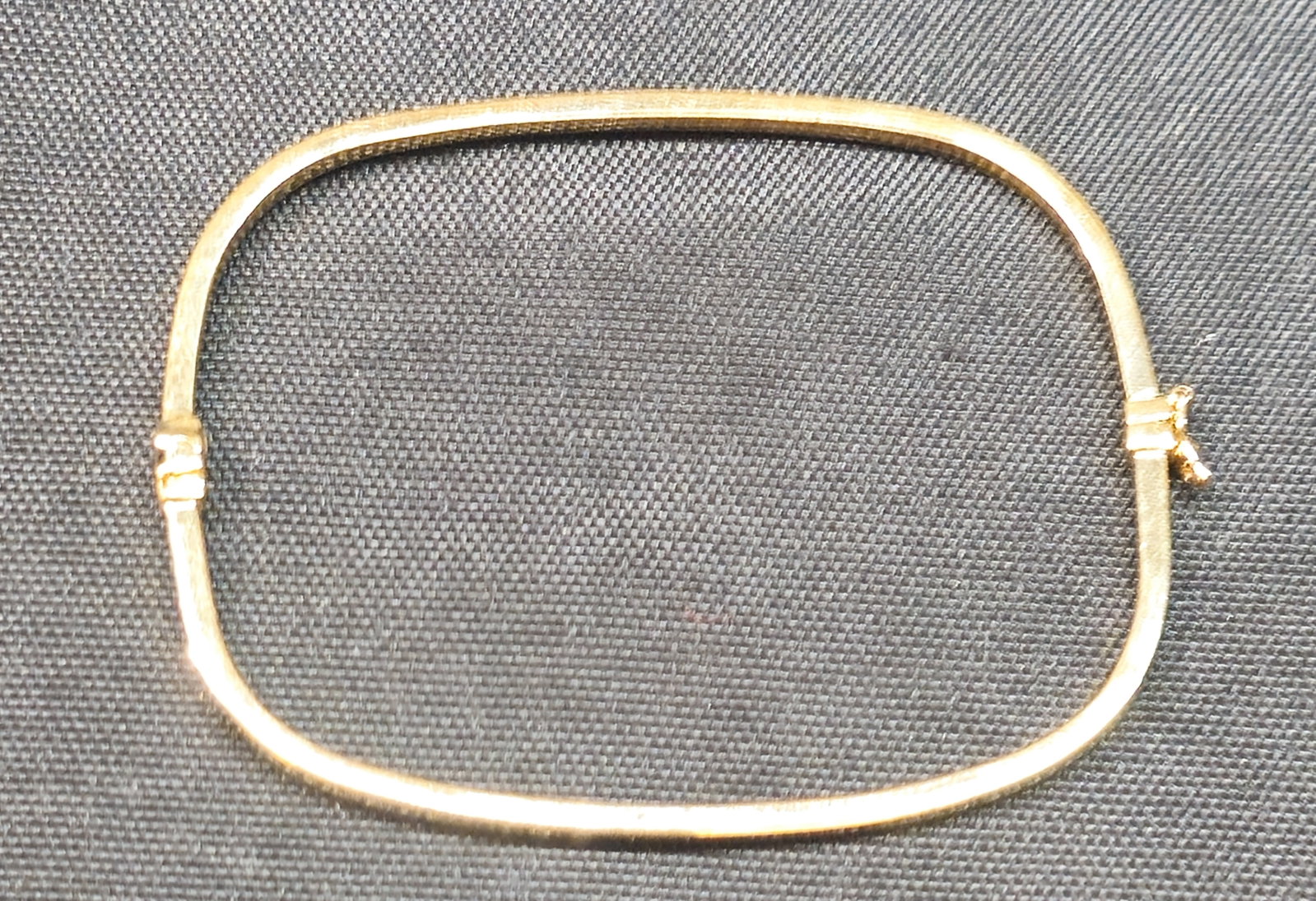 14K Yellow Gold Hinged Bangle Bracelet: 14K yellow gold hinged bangle bracelet with box clasp and safety catch. Marked 14K to hinge. 3.8 grams.