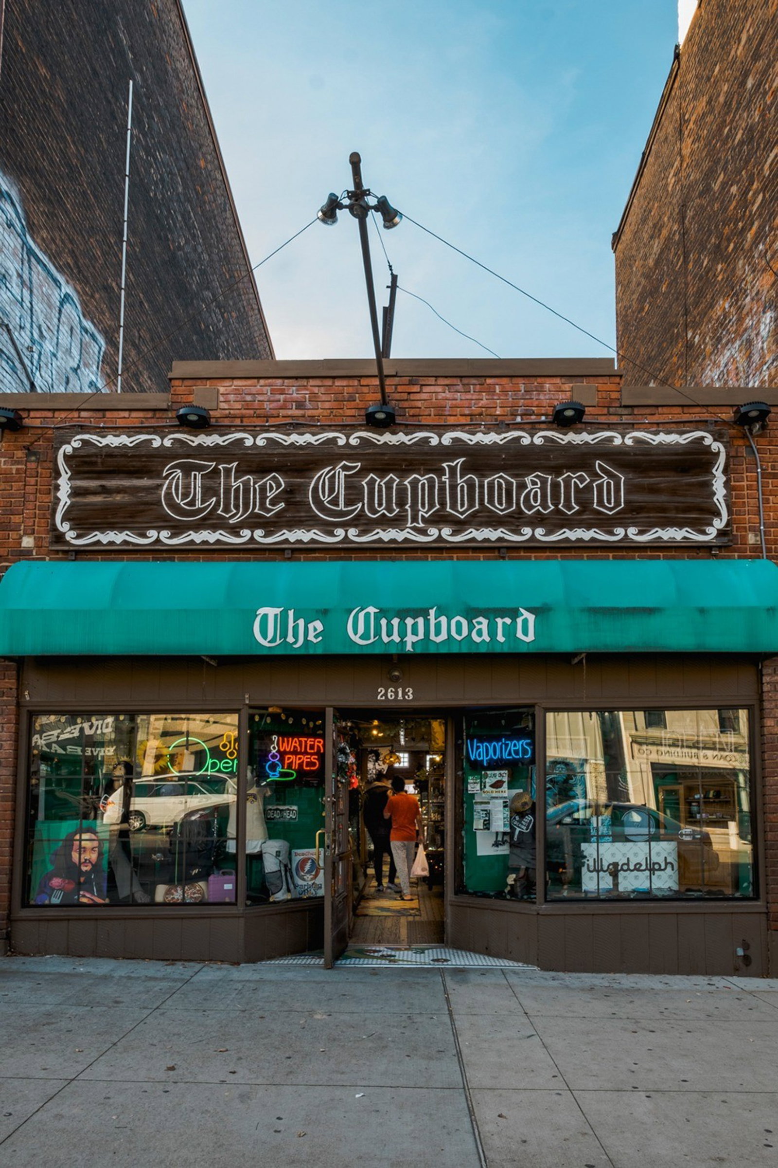 Original "The Cupboard" Cincinnati Painted Wood Storefront Sign: Monumental original storefront sign from The Cupboard, the legendary Cincinnati smoke shop and counterculture institution formerly located at 2613 Short Vine Street in Corryville, near the University 
