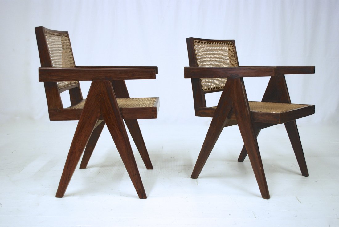 Pierre Jeanneret: Pair of arm chairs from Chandigarh, France/India, 1955. Teak and cane. Teak surface has recently been sensitively cleaned and lightly over coated, preserving patina and character of chair. Old gauges,