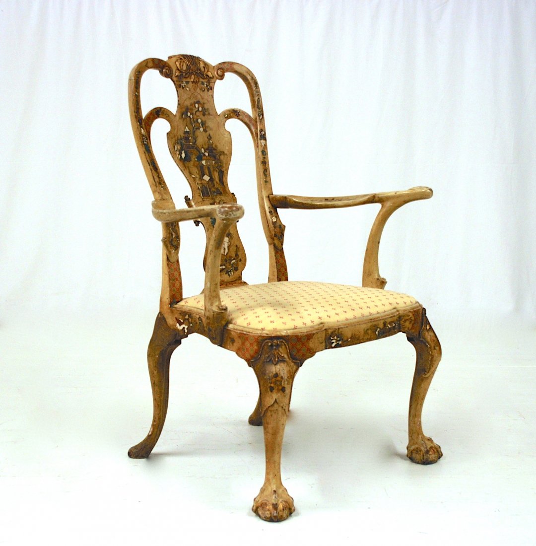 Jacobean Style Carved Arm Chair: In Oak circa 1920 with elaborate carved back with floral scrollwork and two vases with flowers, turned finials on posts, scrolled arms with acanthus leaf & sunflower carved ends, turned & fluted legs