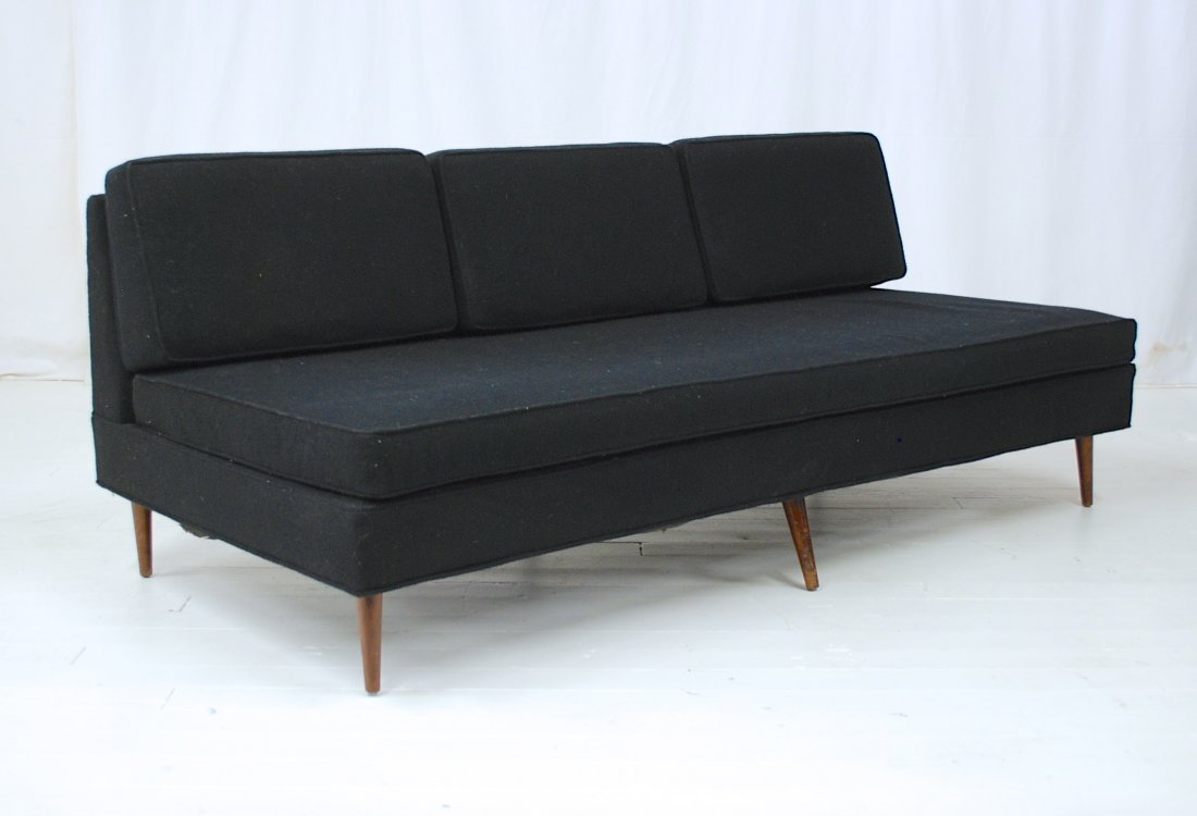 Jens Risom: Walnut four loose cushion armless sofa. Walnut tapered legs. 73.5L x 39D x 27H