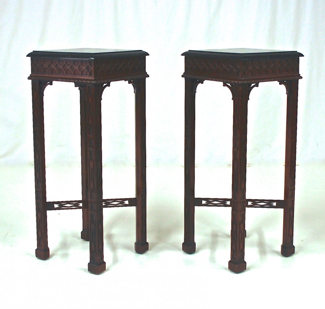 Maitland Smith: Mahogany in the Gothic style with gothic tracery designs throughout, square legs with pierced stretchers, black marble tops, 14.75” square x 36” high, circa 1950.