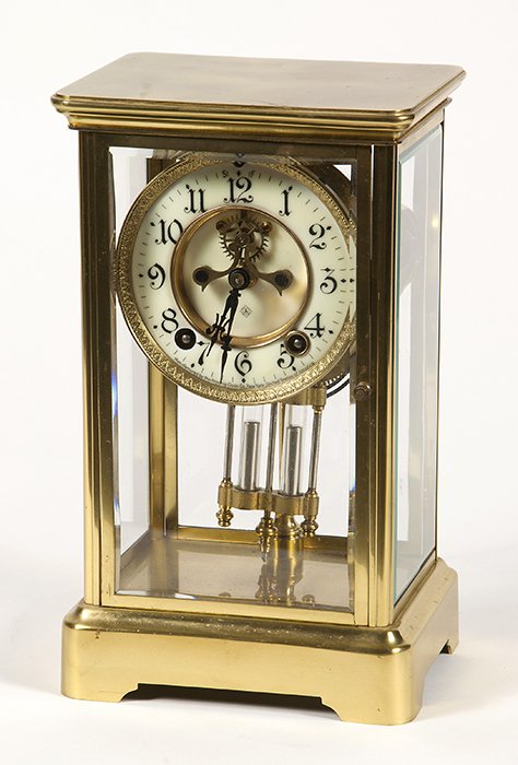 Ansonia Crystal Regulator Clock: Brass case with flat top and bracket base, beveled glass sides and doors in front and rear, porcelain dial with open escapement and Arabic numerals marked “Manufactured by the Ansonia Clock Co., New