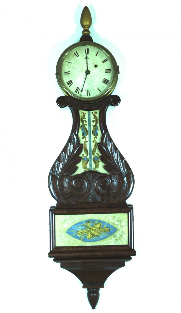 19th Century Banjo Clock: Carved Mahogany case, teardrop finial, reverse painted decoration on glass. Key wind with movement, brass trim, hand painted face, gilt wood finial, original key. 11.5w x 4d x 40.5h. From a Prominent 