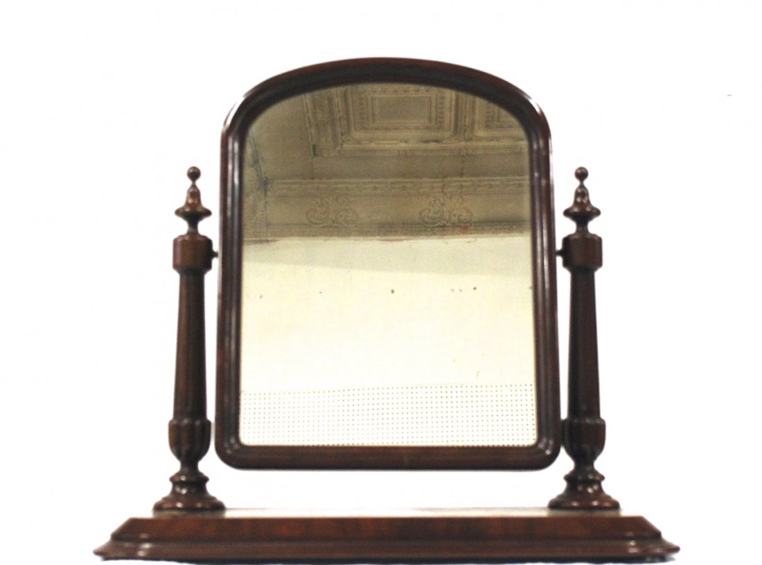 Federal Dressing Mirror: Mahogany with stop fluted columns with turned finials and plinths, ogee arch top mirror with brass mounts on an ogee base with bun feet, 28.5 x 10.5 x 26” high. From the Estate of William Applegarth