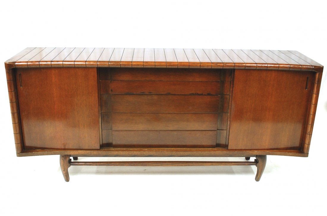 Harold Schwartz: Solid Oak sideboard/credenza, Romweber 1950's, scalloped ribbed curved top and sides with sculptured legs, Five center drawers with two sliding doors, two side compartments have sliding adjustable she